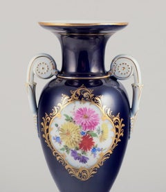 Meissen, Germany. Porcelain vase in Sevres Bleu. Polychrome flower motifs.