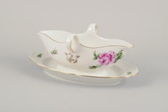 Meissen, Germany. Sauce boat on a stand with a motif of a pink rose.