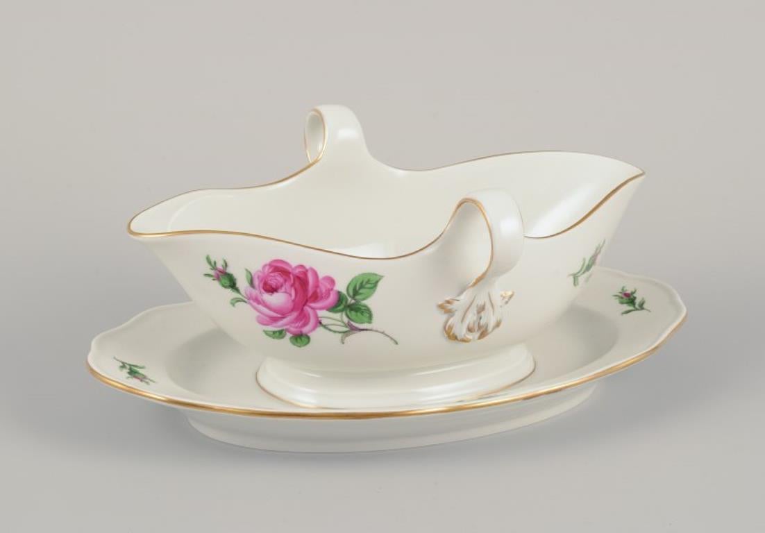 Meissen, Alemania. Bote de salsa sobre un soporte con un motivo de una rosa rosa. Borde dorado.
Aproximadamente 1920/30s.
En perfecto estado. Como nueva.
Marcado.
Quinta calidad de fábrica.
Dimensiones: Largo 24,0 cm. x Ancho 15,0 cm. x Alto 10,0 cm.