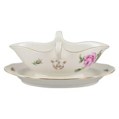 Meissen, Germany. Sauce boat on a stand with a motif of a pink rose.