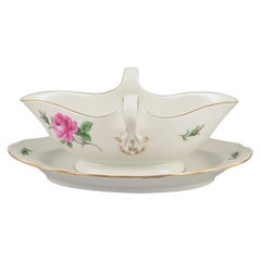 Meissen, Germany. Sauce boat on a stand with a motif of a pink rose.