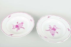 Meissen, Germany. Three deep porcelain plates with floral motifs in purple/pink.