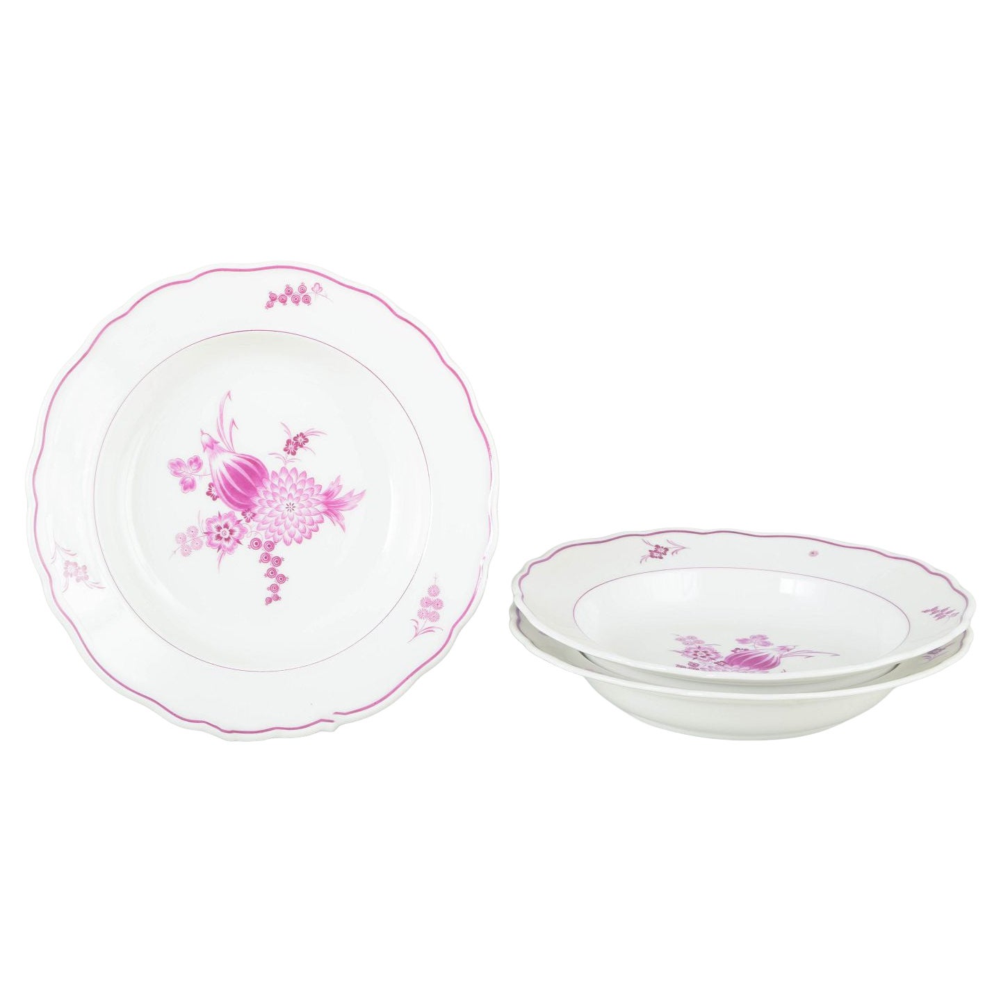 Meissen, Germany. Three deep porcelain plates with floral motifs in purple/pink.