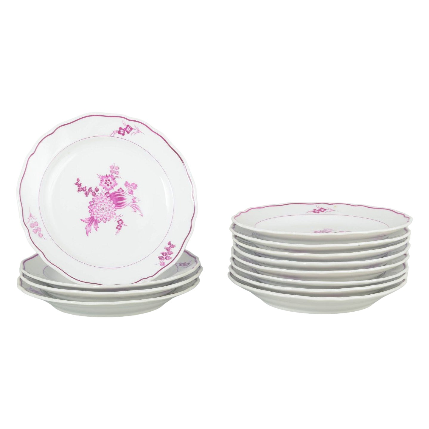 Meissen, Germany. Twelve deep porcelain plates with floral motifs in purple/pink