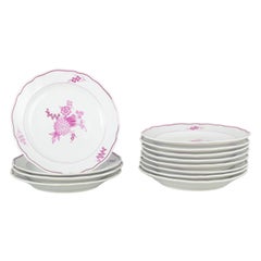 Meissen, Germany. Twelve deep porcelain plates with floral motifs in purple/pink