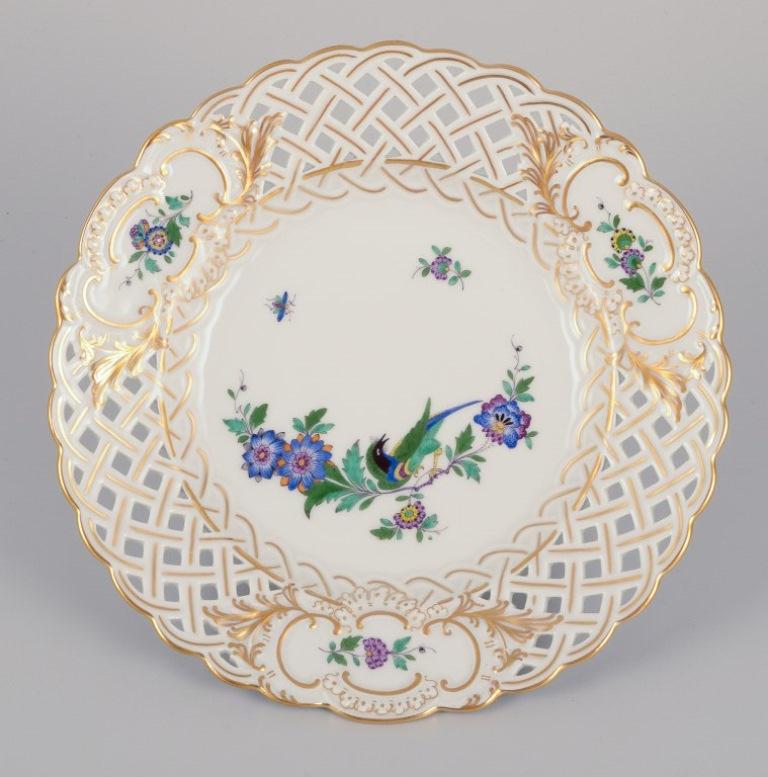 Meissen, Germany. Two open lace plates in porcelain, decorated in gold with an exotic bird on a flowering branch.
Mid-20th century.
Marked.
First factory quality.
In perfect condition.
Dimensions: Diameter 18.5 cm x Height 2.8 cm.