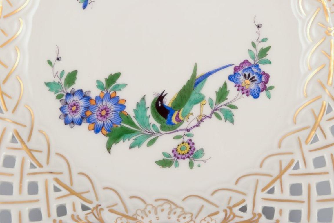 Hand-Painted Meissen, Germany. Two open lace plates in porcelain, decorated with exotic bird For Sale