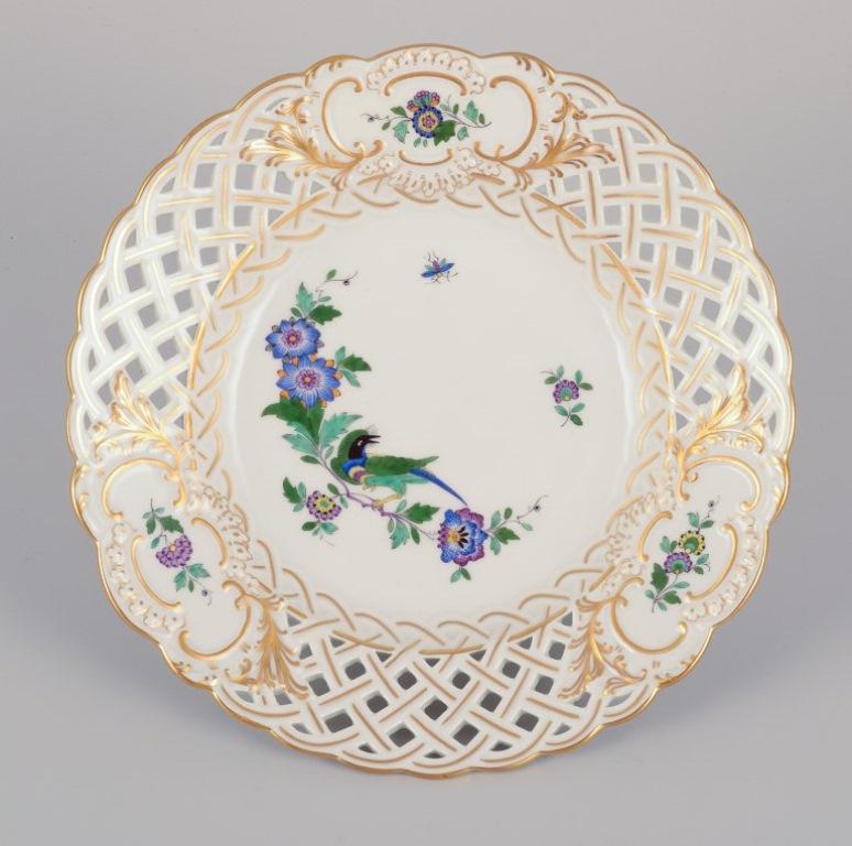 20th Century Meissen, Germany. Two open lace plates in porcelain, decorated with exotic bird For Sale