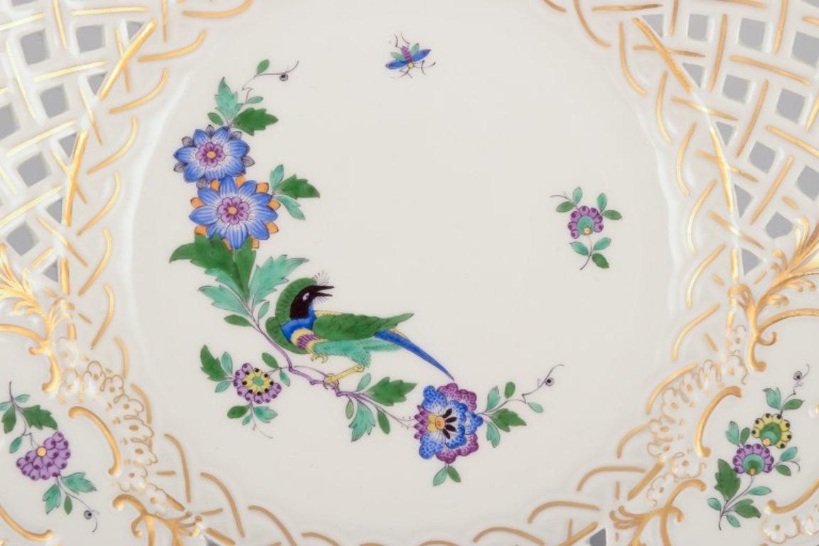 Porcelain Meissen, Germany. Two open lace plates in porcelain, decorated with exotic bird For Sale