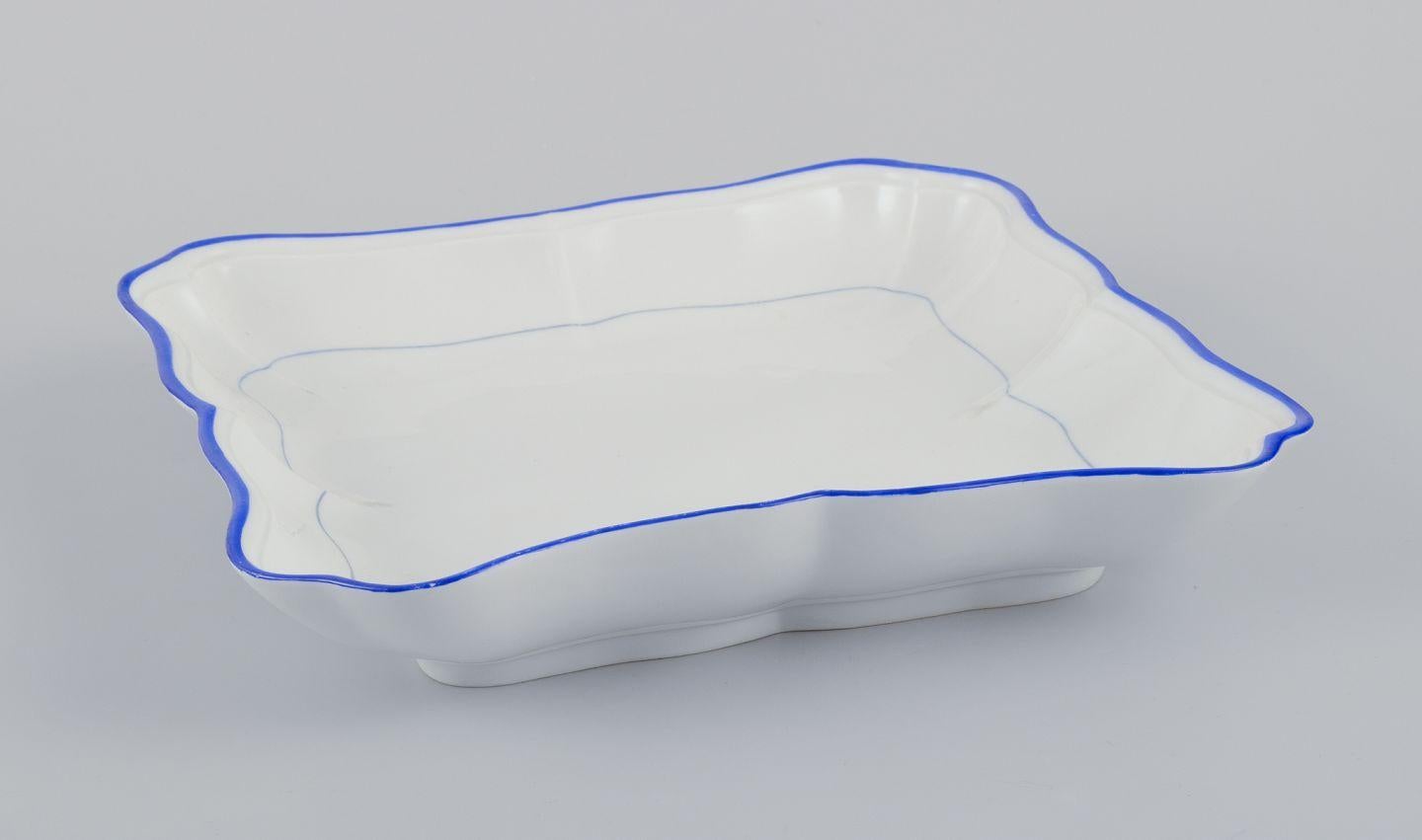 PRE-OWNED GOODS ARE EXEMPT FROM IMPORT TARIFFS FOR U.S., UK, AUSTRALIAN & CANADIAN CUSTOMERS.   
THEREFORE, NO IMPORT TARIFFS WILL BE APPLICABLE TO YOUR PURCHASE. 

Meissen, Germany. Two square bowls of white porcelain, blue rim.
Early 20th