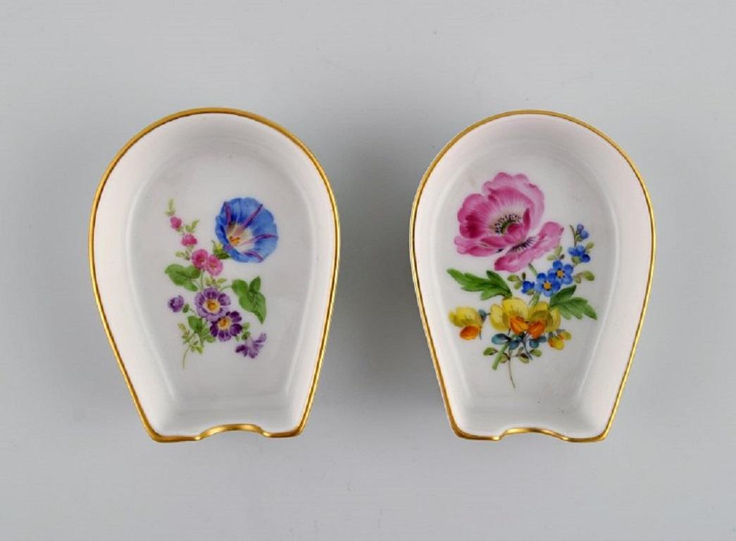 Meissen, Germany. 
Two vases and two small bowls in hand-painted porcelain with flowers and gold rims. Early 20th century.
Largest vase measures: 10.5 x 8.5 cm.
The bowl measures: 8 x 2.2 cm.
In excellent condition.
Signed.
1st factory quality.