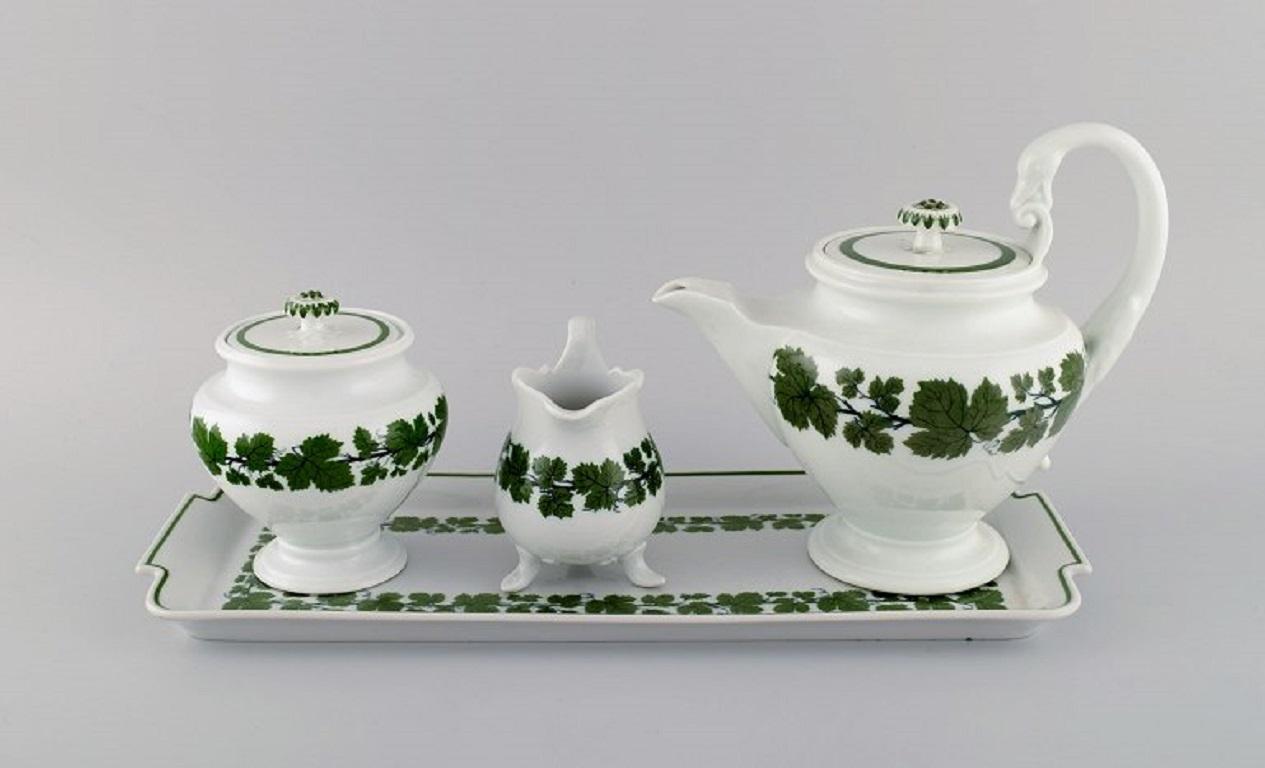 Meissen Green Ivy Vine Leaf. Teapot, sugar bowl, cream jug and serving tray in hand-painted porcelain. 1940s.
The teapot measures: 20.5 x 19 cm.
The sugar bowl measures: 12 x 11 cm.
The serving tray measures: 39 x 15 cm.
In excellent