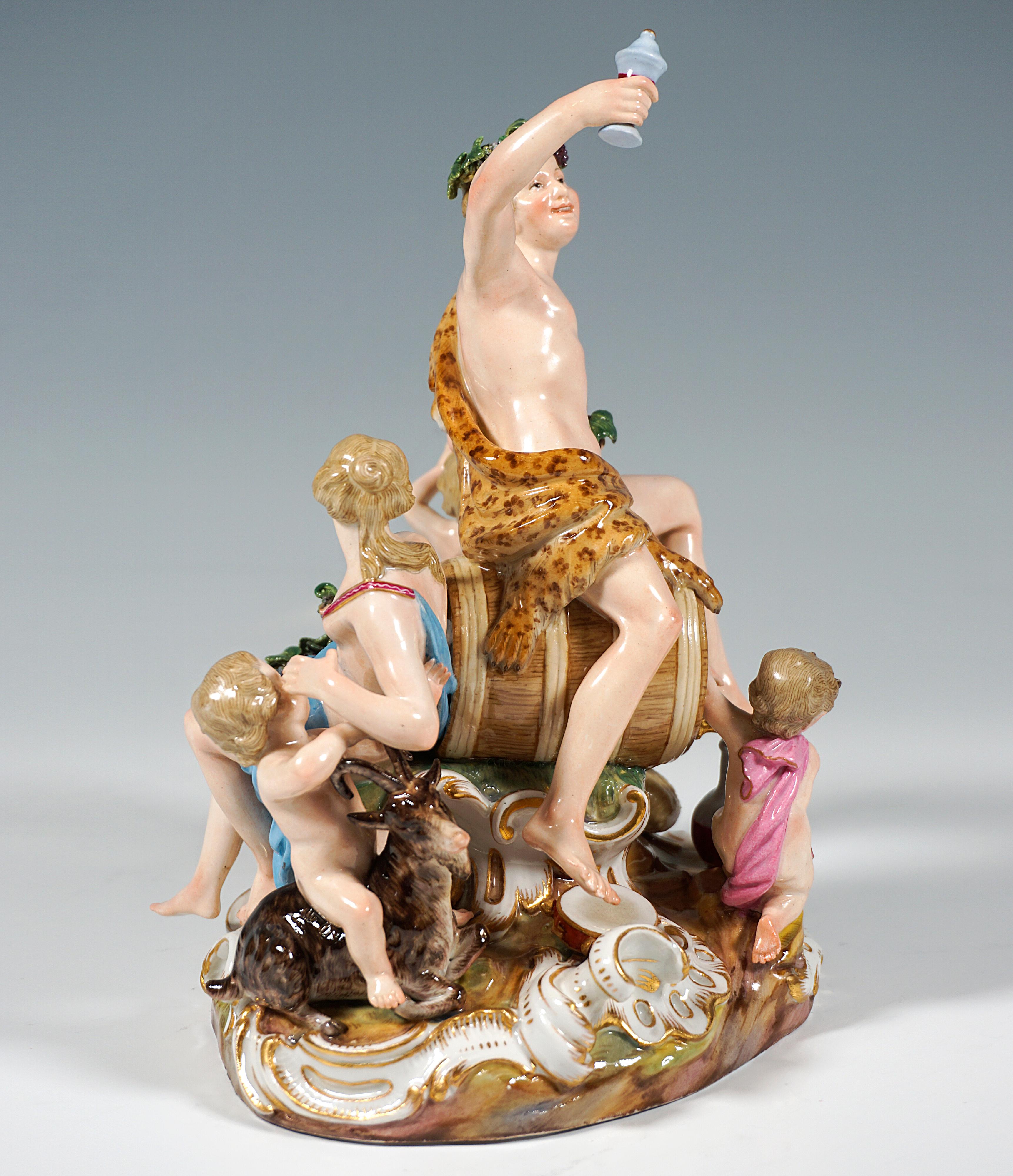 Rare, excellent porcelain group of the 19th century:
Youthful Bacchus with nymph and putti grouped around a large wine cask: The Bacchant, covered with a leopard skin, sitting sideways on the barrel, holding up grapes in his left hand and a wine