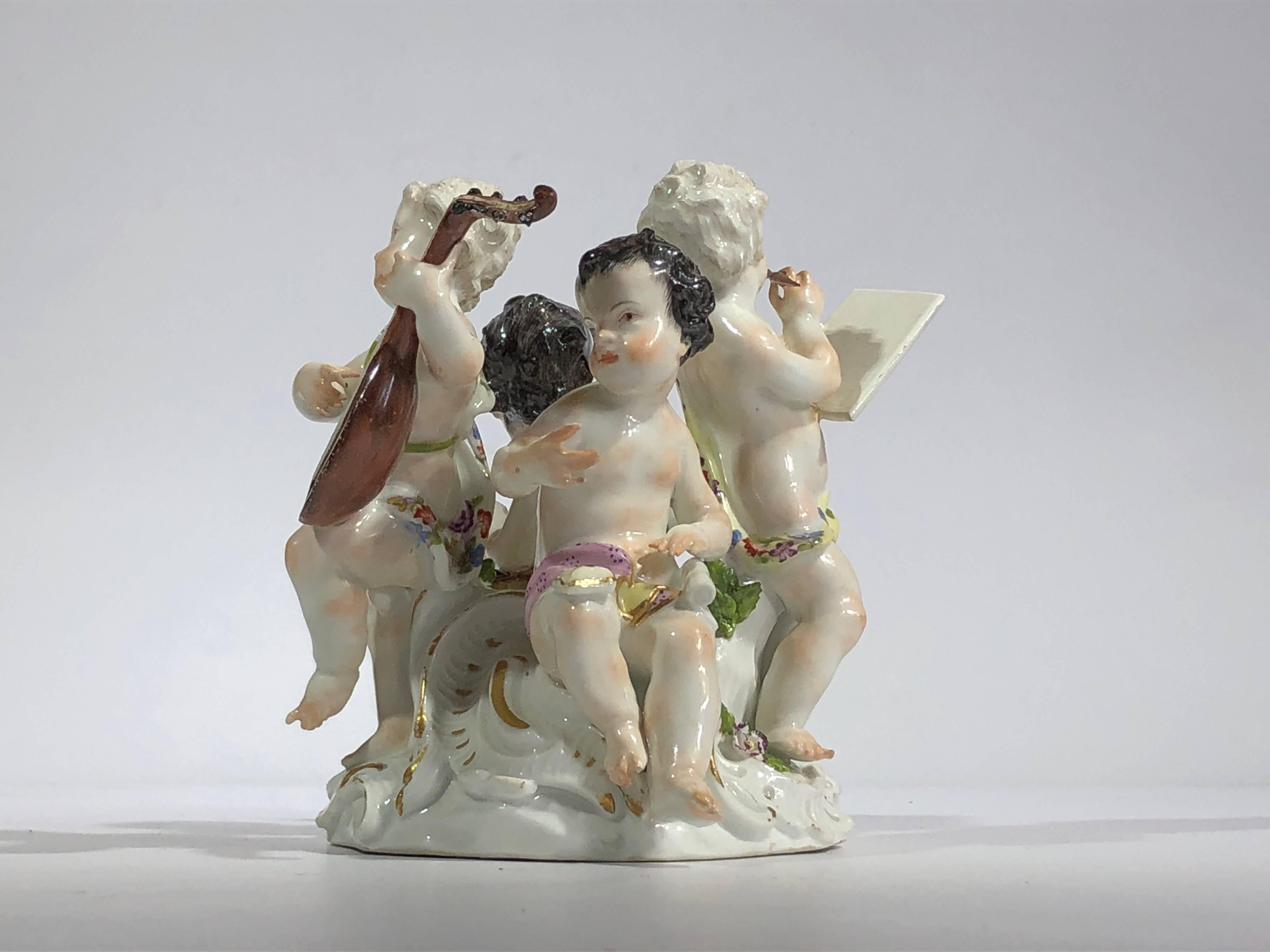 Meissen group of children, representing 'The Arts', with a Mathematician writing numbers in a book and inkwell and sander to his side, an artist with brush and canvas, a writer with sealed envelope and scroll, and a musician with a lute, all set on