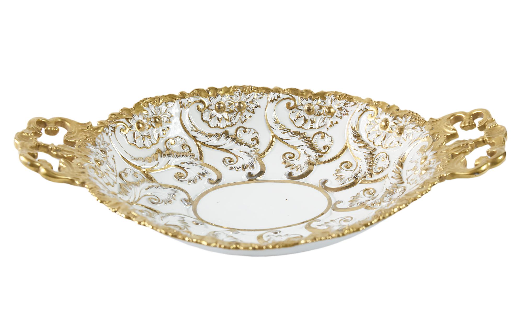 Meissen Porcelain plate/bowl with relief floral motives hand painted in gold.
Measurements: 39 x 25 x (H) 8 cm.