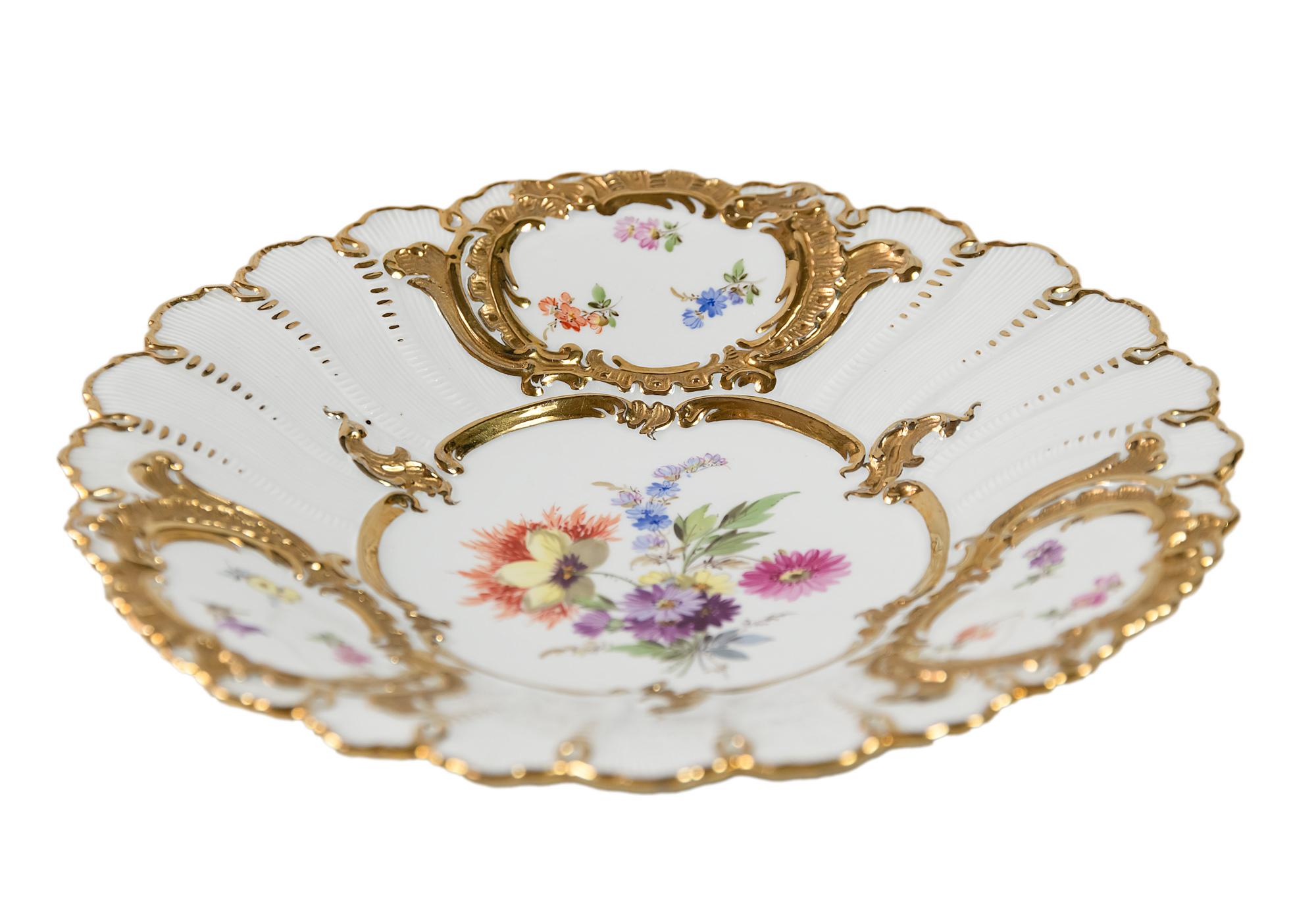 Meissen Porcelain plate with hand painted floral motives and gold decor.