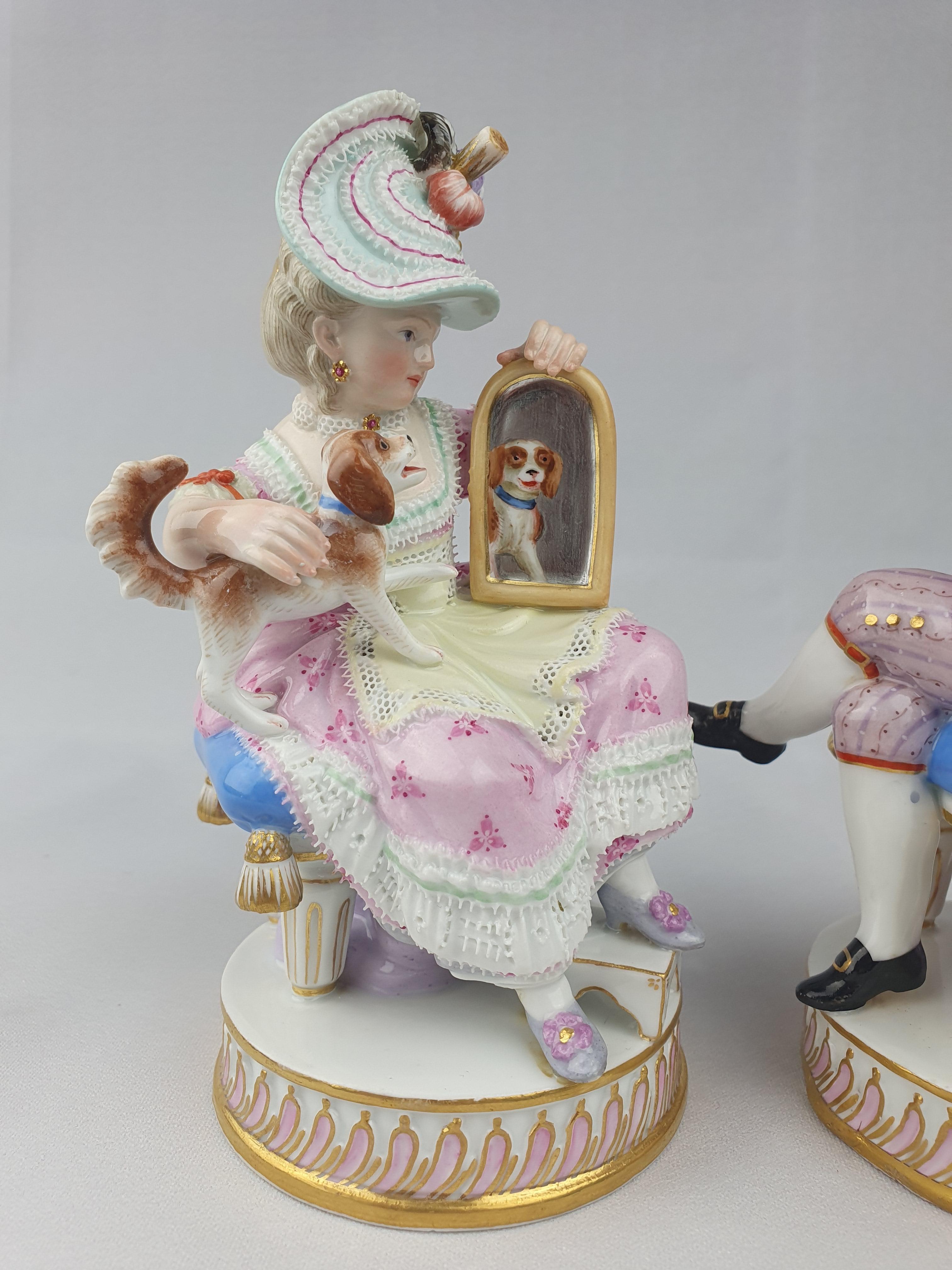 Modelled as a huntsman seated on a stool holding a gun, with a dog at his feet, on a circular plinth base, his female companion similarly modelled seated on a stool holding a hound and a mirror, on similar base. First modelled by Acier c1776.

Circa