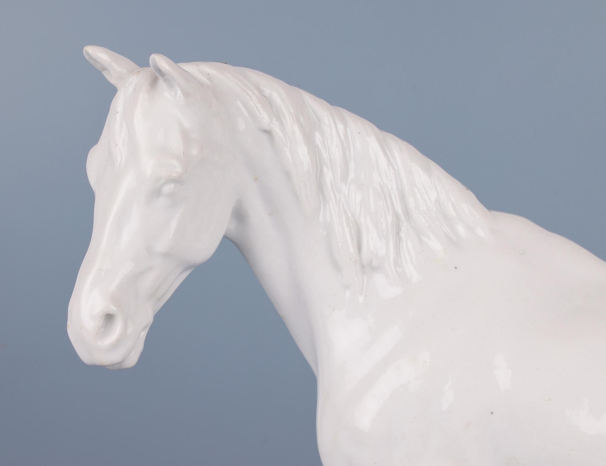 A fine antique Meissen porcelain blanc de chine figure of a Stallion from the Marcolini period dating between 1774 and 1814. This finely made and large figure of a Stallion stands with its head turned to one side with wonderful natural detail to the