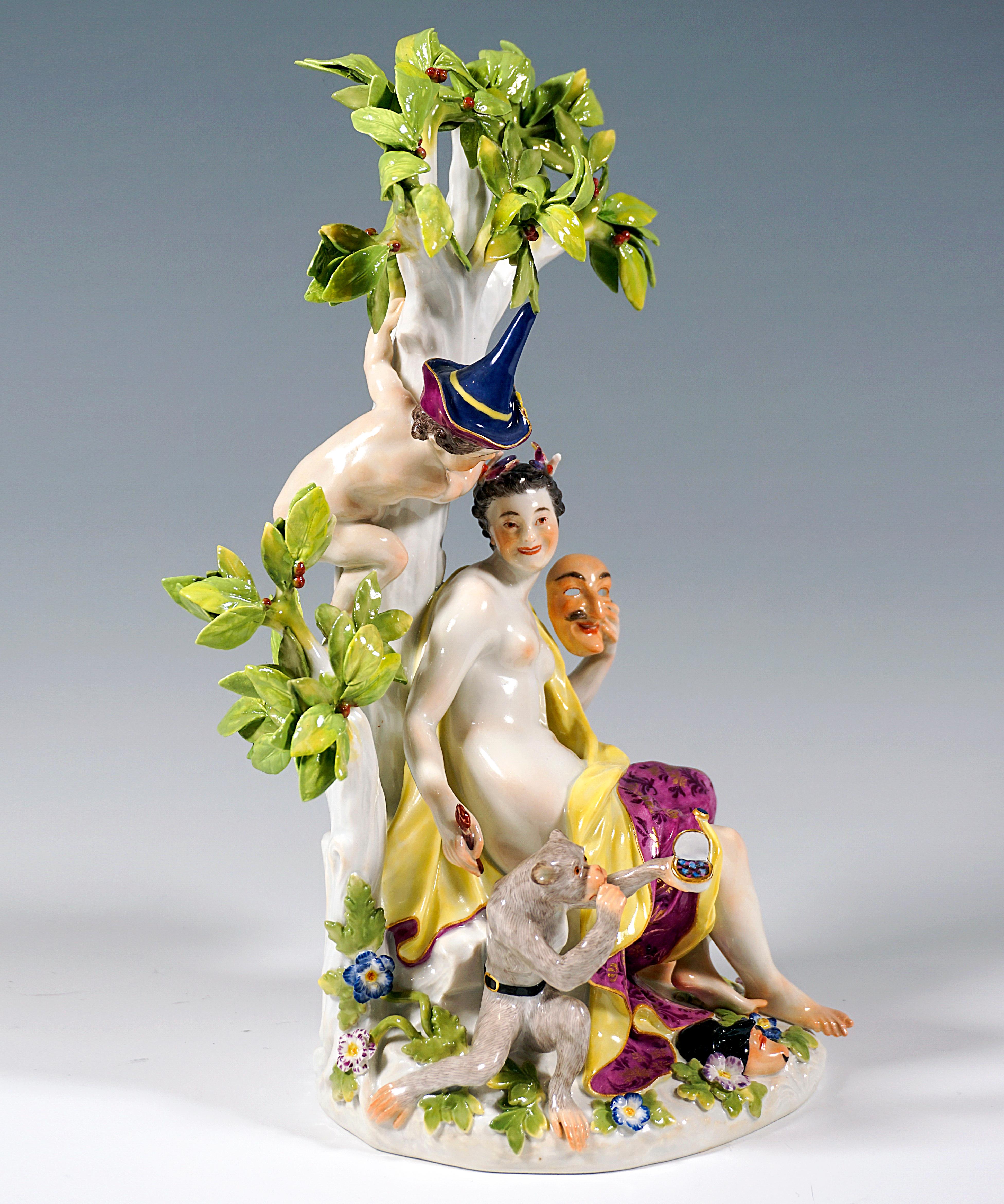 Very rare Meissen group:
Thalia, the muse of theater and comic poetry, covered only with a large cloth, smiling and sitting on a rock under a cherry tree, holding a mask next to her face in her left hand, a paintbrush in her right, other comic