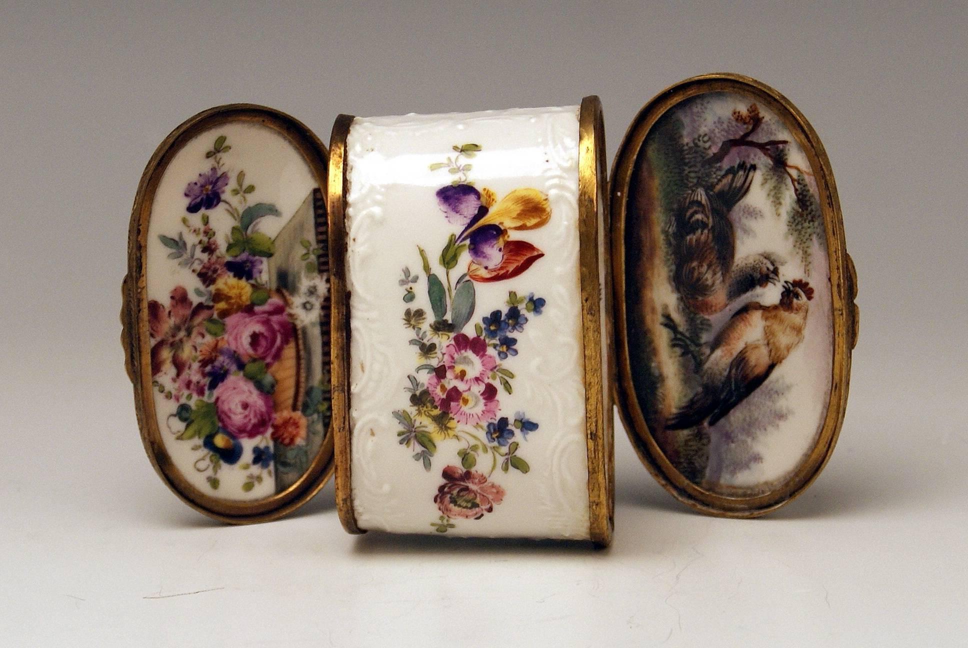 Meissen Gorgeous Dual Lidded Rococo Box with Multicolored Paintings and Decorations of Relief Type. 
The box is edged by brass mountings.
 
height:  6.0  cm   (= 2.36 inches) 
width:   8.0  cm   (= 3.14 inches) 
depth:   4.5  cm   (= 1.77 inches)