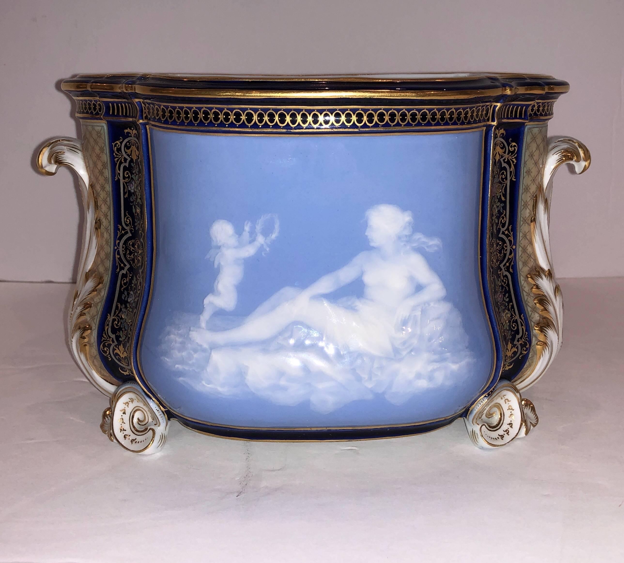 A very fine and rare Meissen Pate Sur Pate porcelain centerpiece. Depicting cupid and psyche, crafted using Pate Sur Pate technique, the subjects are positioned against a sky blue background. A cobalt blue with raised enamel compliments the