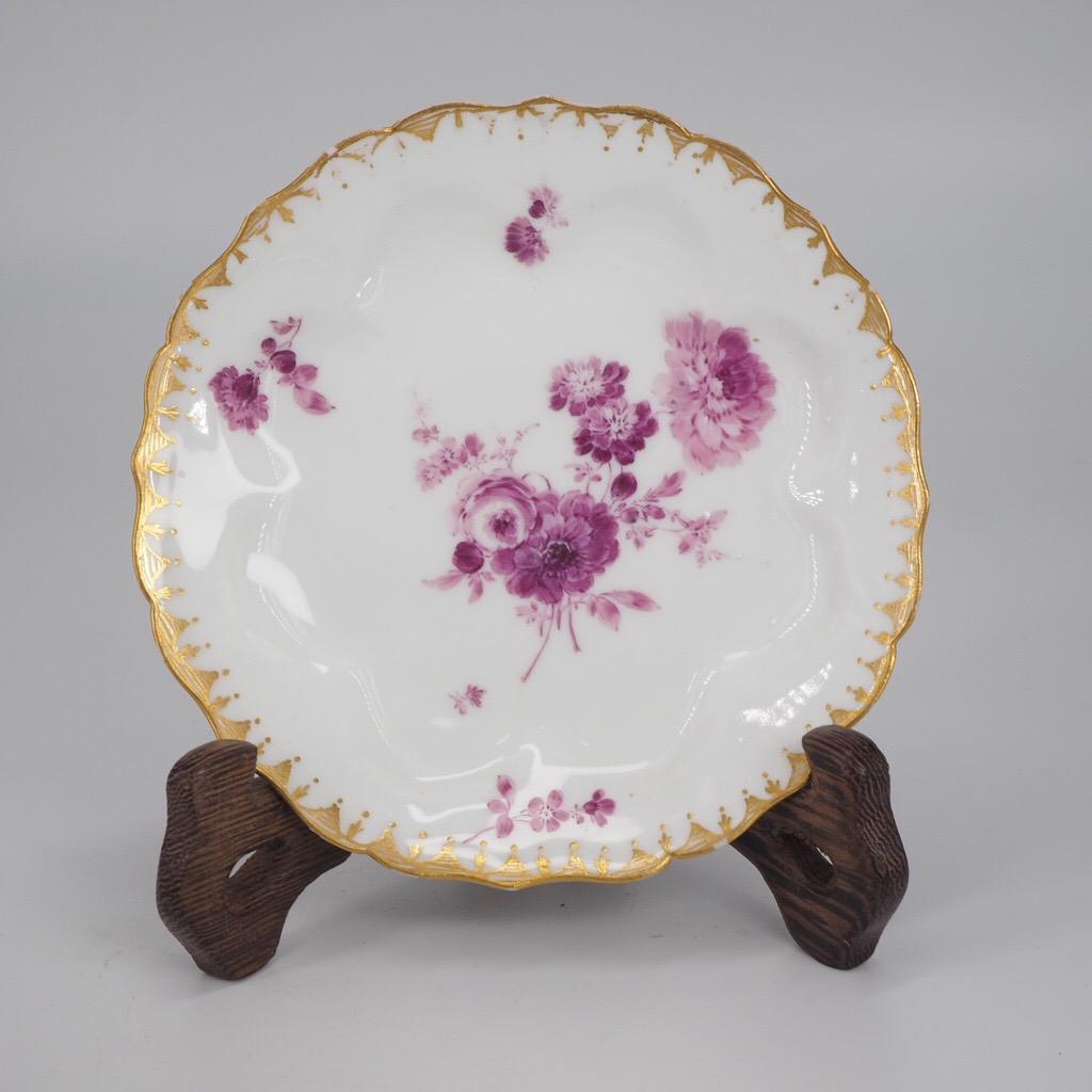 Meissen petal moulded lobed rim teabowl & saucer, the petals with flower groups in purple within gilt line borders, with scattered flower groups throughout, the saucer with larger scale flower groups, the rim with a trifoil & dot gilt border.