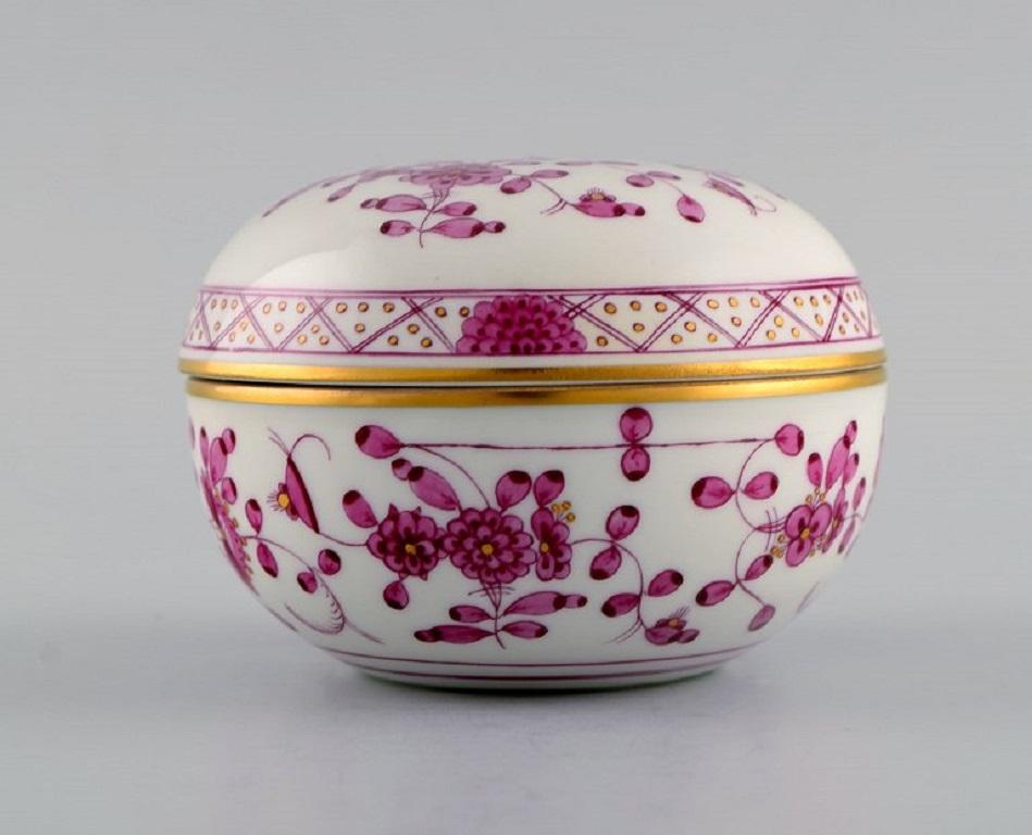 Meissen Pink Indian lidded trinket box in hand-painted porcelain. 
Pink flowers and gold decoration. Early 20th century.
Measures: 9.5 x 7 cm.
In excellent condition.
Stamped.
1st Factory quality.