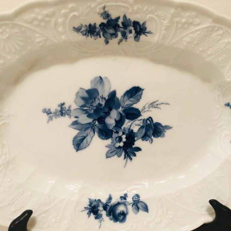 If you love blue and white, and you also love flowers, this wonderful platter has it all and more. You can see a large beautifully painted flower bouquet in the center with four smaller blue flower bouquets around its border with a white colored