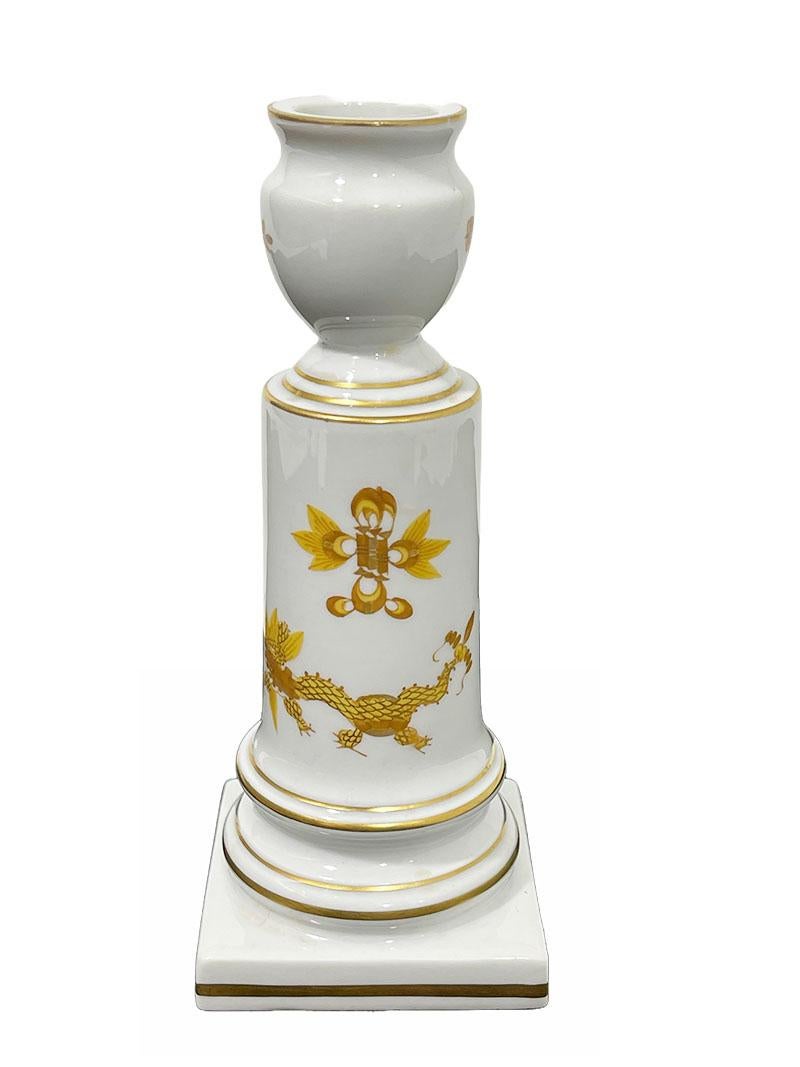 Meissen Porcelain candlestick holder ornate yellow Dragon

Meissen Porcelain ornate yellow Dragon candlestick holder. The rims and pattern are gilded. A small candle holder raised on a square foot in the shape of a column the Ornate Dragon
