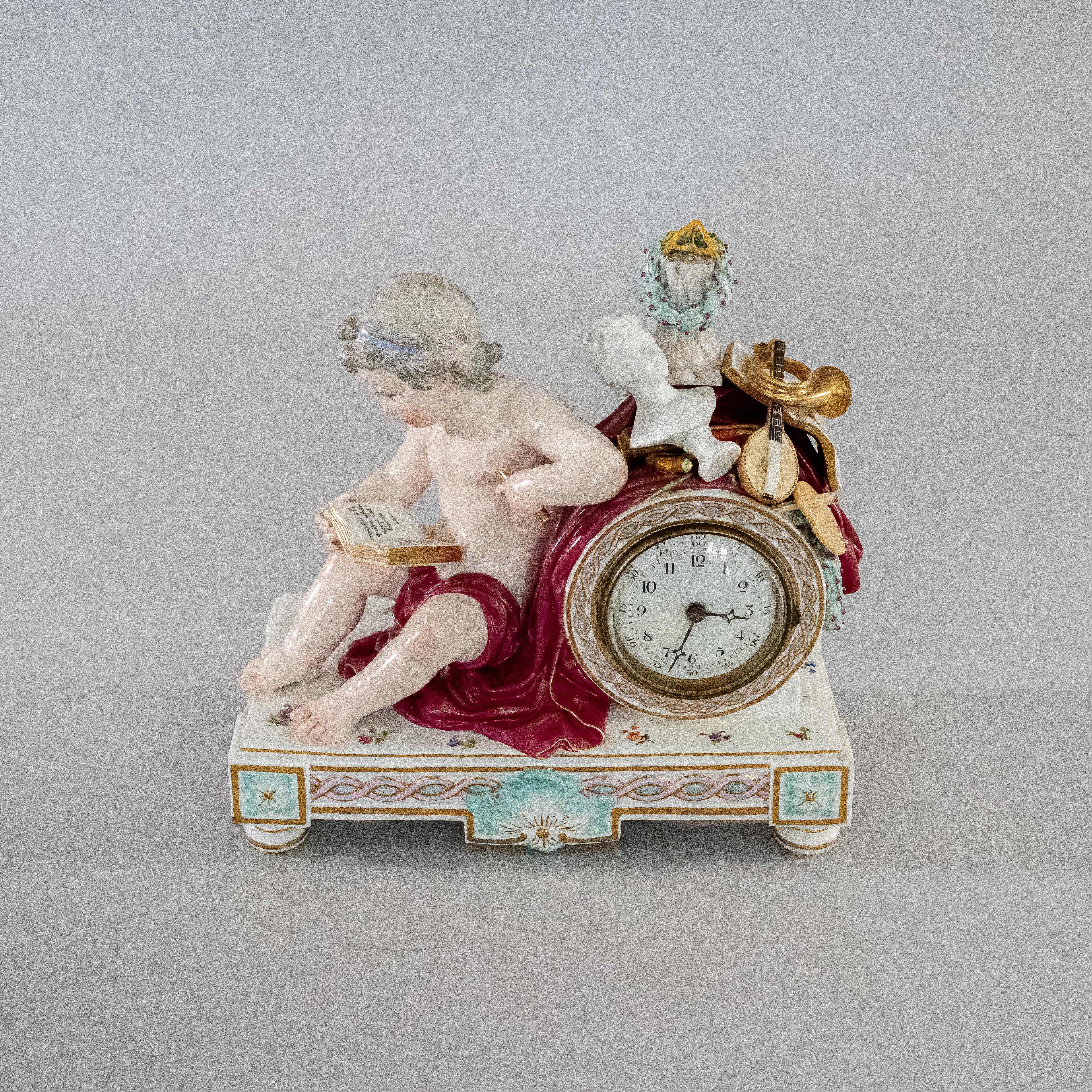 19th century German Meissen Porcelain figural mantle clock. Seated figure of a nude Putti reading a book with his left arm resting on the clock tower, the tower is topped with a robe, instruments and artworks representing industry & the arts, at the