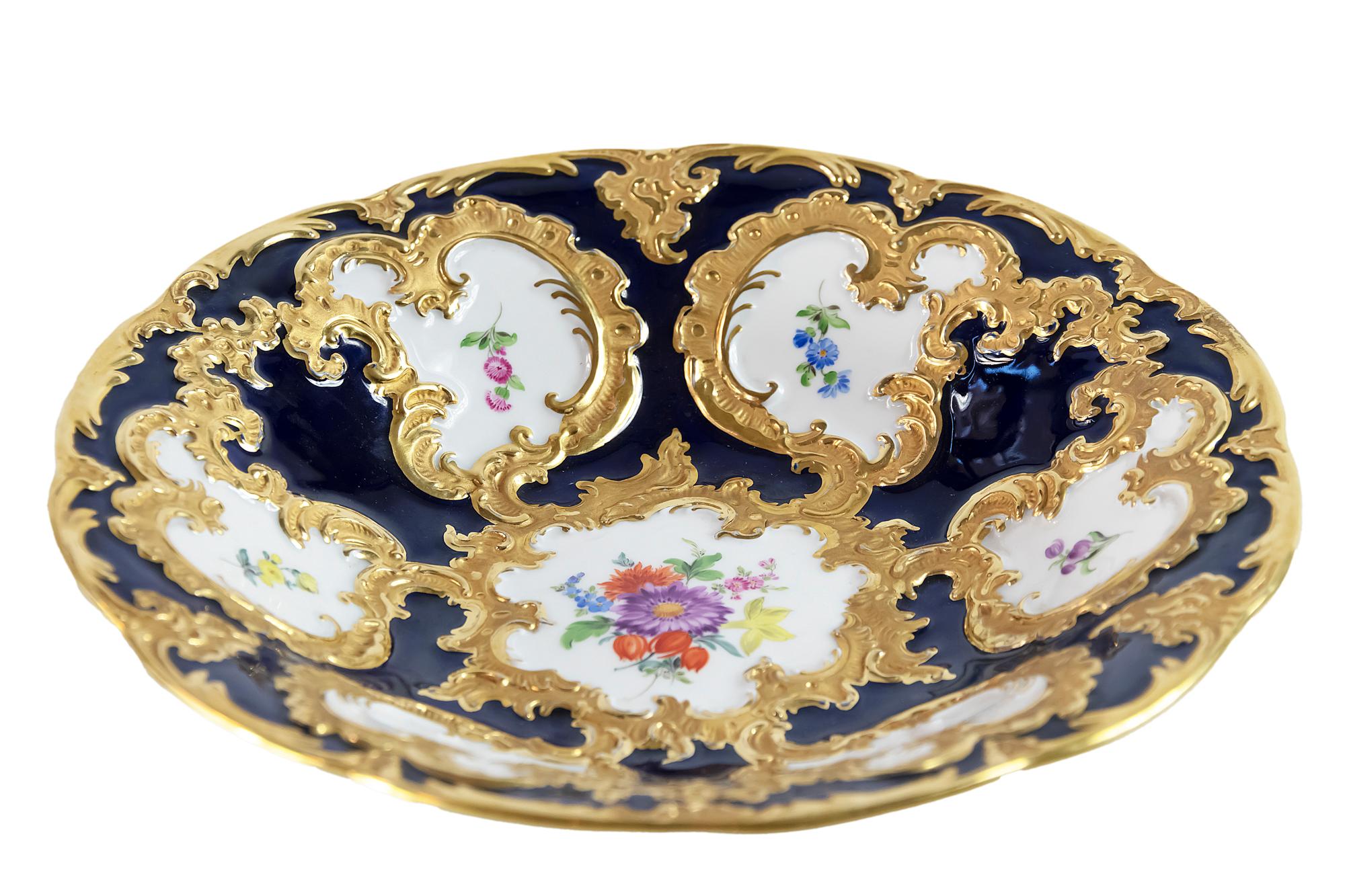 Meissen Porcelain deep cabinet plate/bowl is cobalt blue color with rich gold decor.
It is hand painted with floral motives.