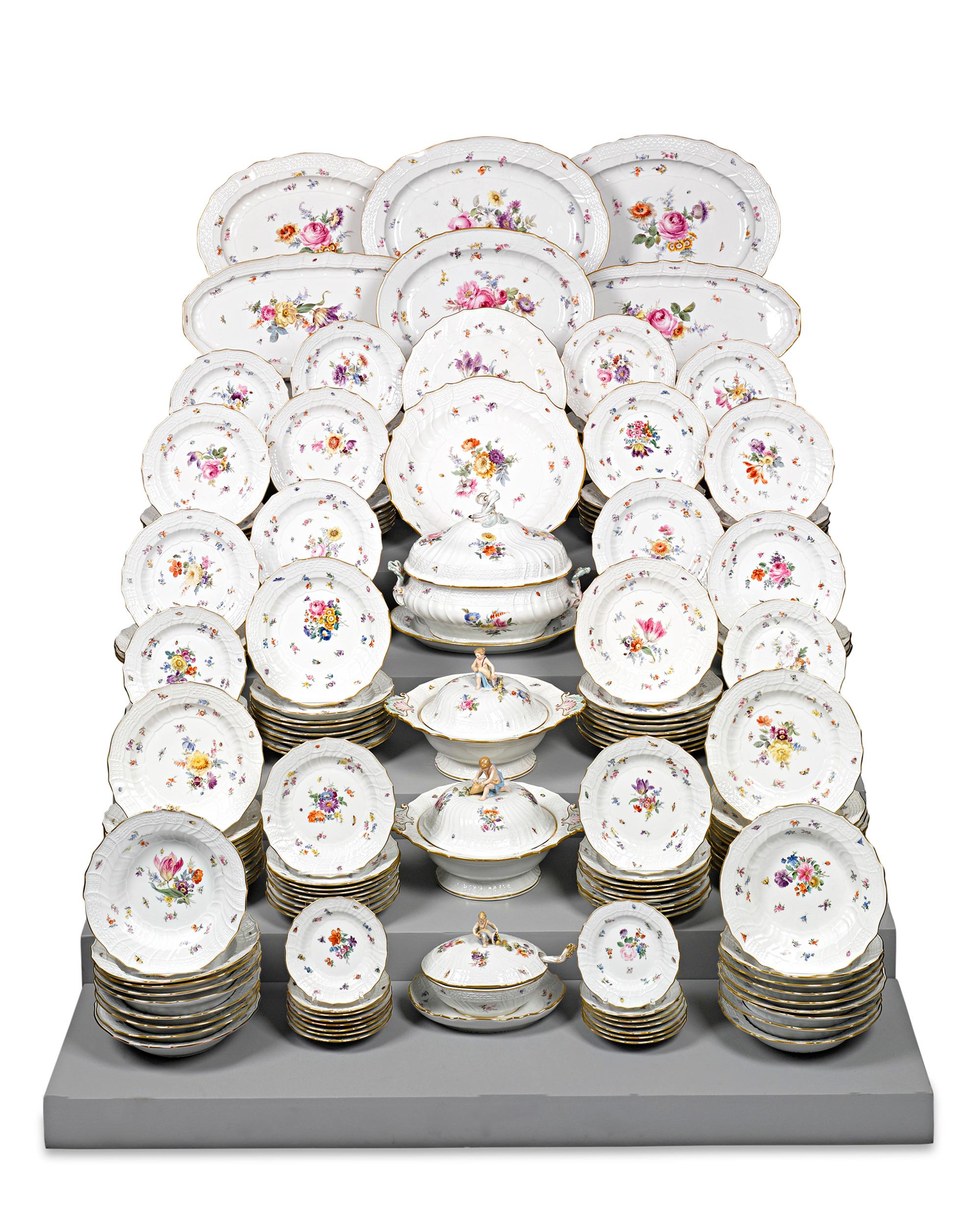 Comprising an incredible 162 pieces, this impressive Meissen porcelain dinner service is an exceptional example of the firm's prized dinnerware. The bodies are crafted in the New Brandenstein relief pattern designed by Johann Friedrich Eberlein in