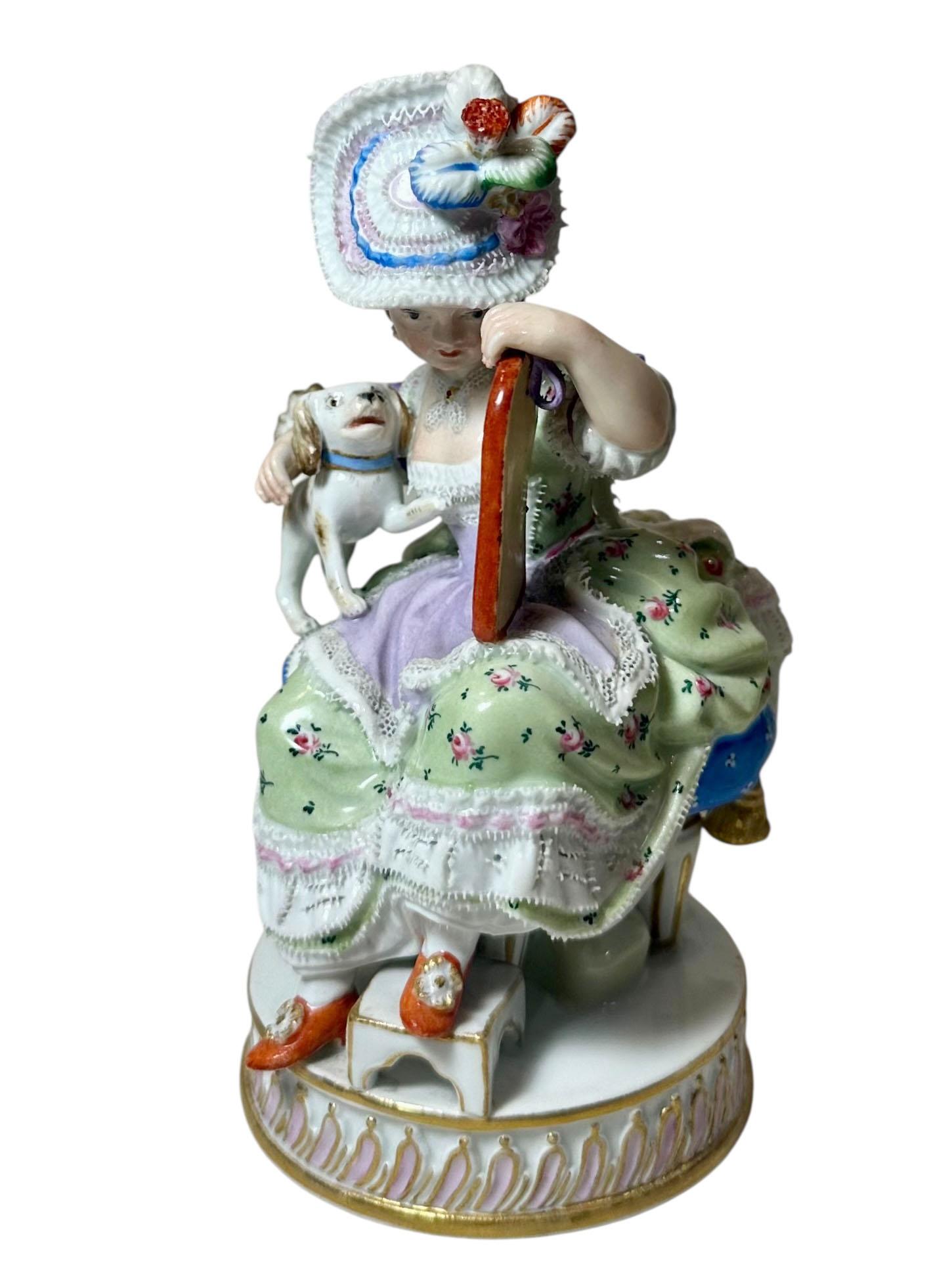 Charming early 19th century Meissen porcelain figure depicting a young girl holding a mirror for her dog, who gazes curiously at his reflection. This beautifully detailed piece captures the whimsy and refinement characteristic of Meissen’s finest