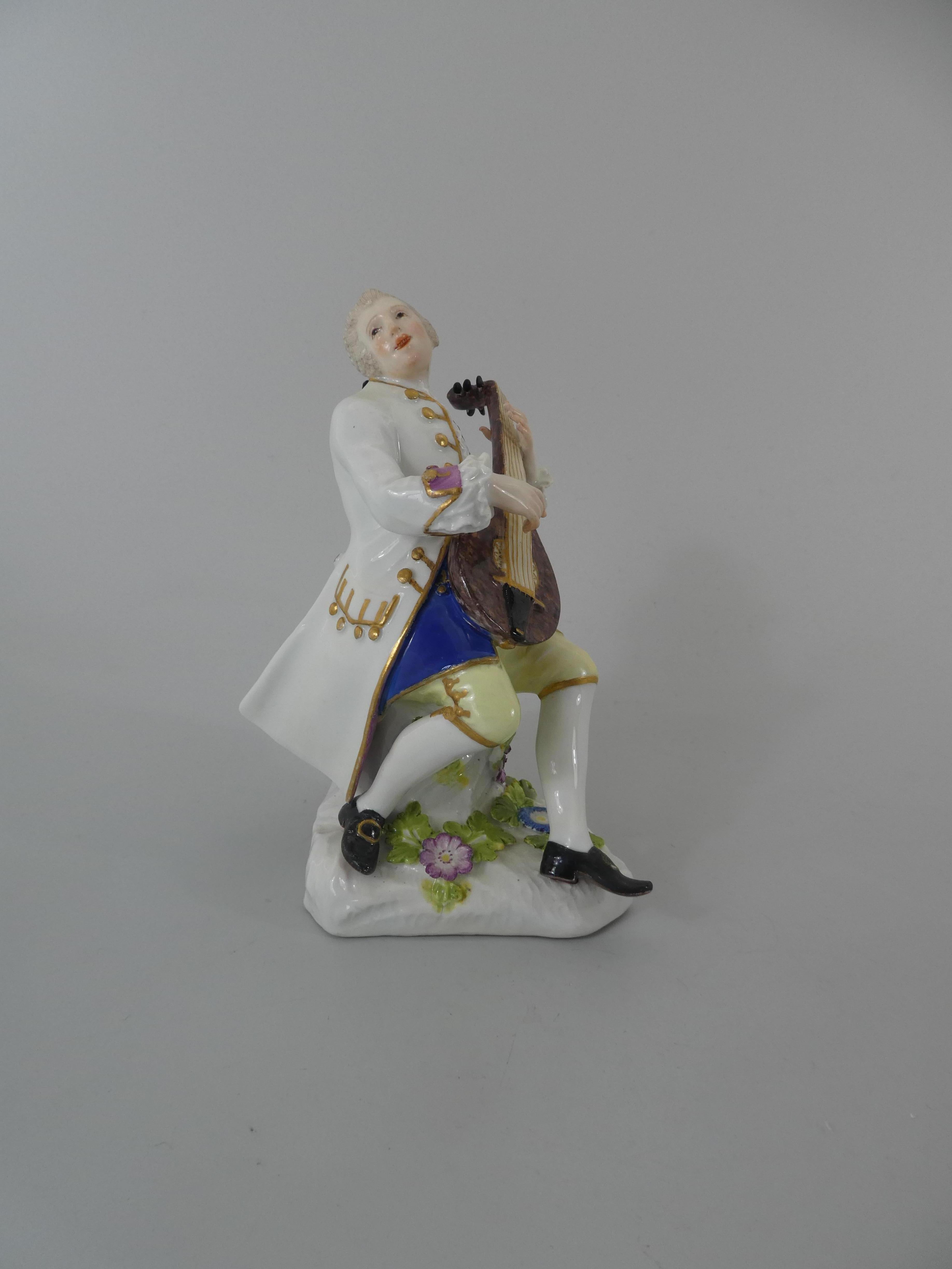 A fine Meissen porcelain figure, circa 1740. Modelled by Peter Reinicke, as seated man playing the lute. He wears a white coat, edged in puce and gilt, and yellow breeches. The irregular shaped base, applied with flowers and leaves.
Blue crossed