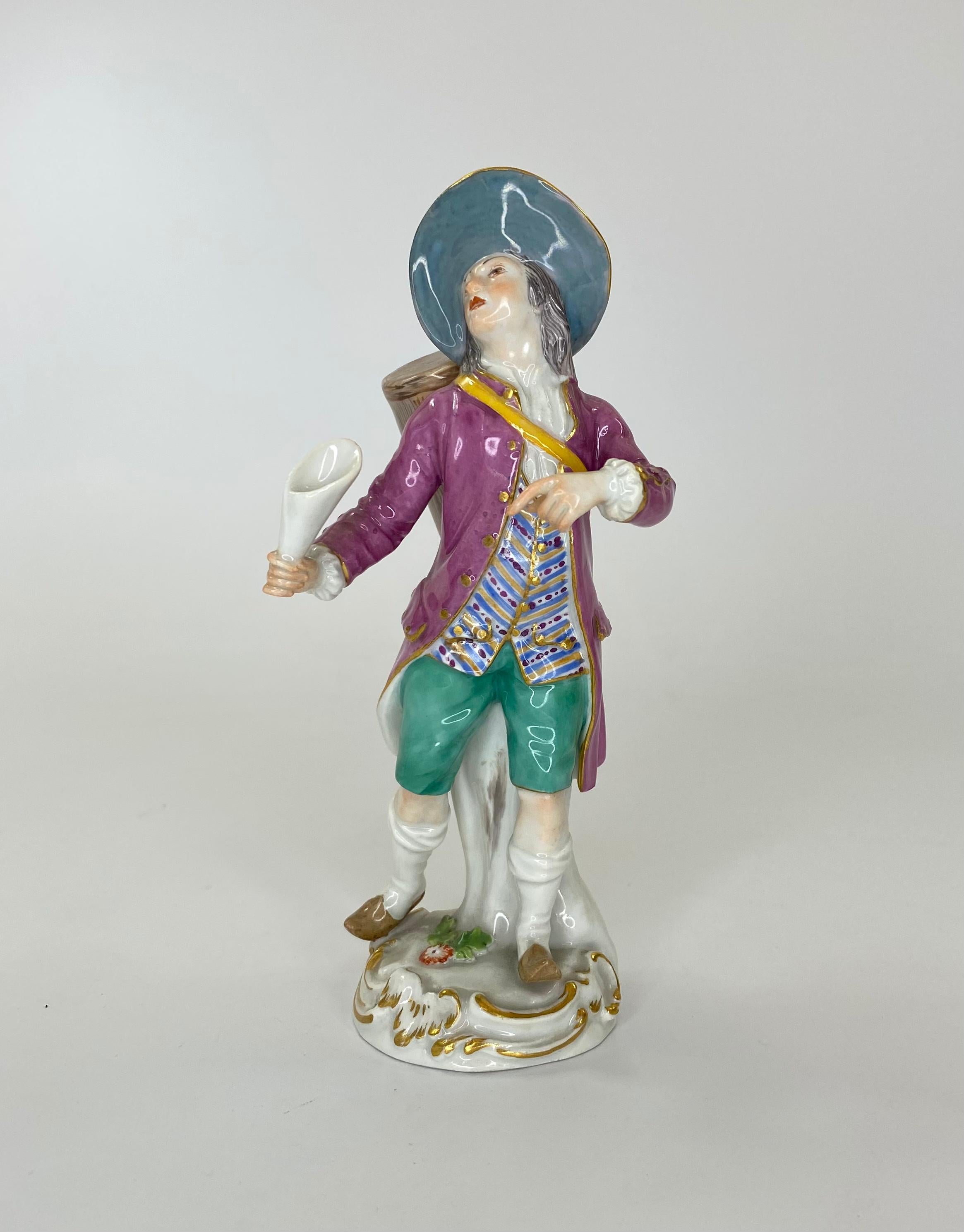 Meissen porcelain figure, ‘The Lottery Seller’, c. 1920. Originally modelled by Peter Reinicke, for the ‘Cris de Paris’ series, the figure depicts a man in 18th century costume, carrying a large drum on his back. Set upon a gilt rocaille