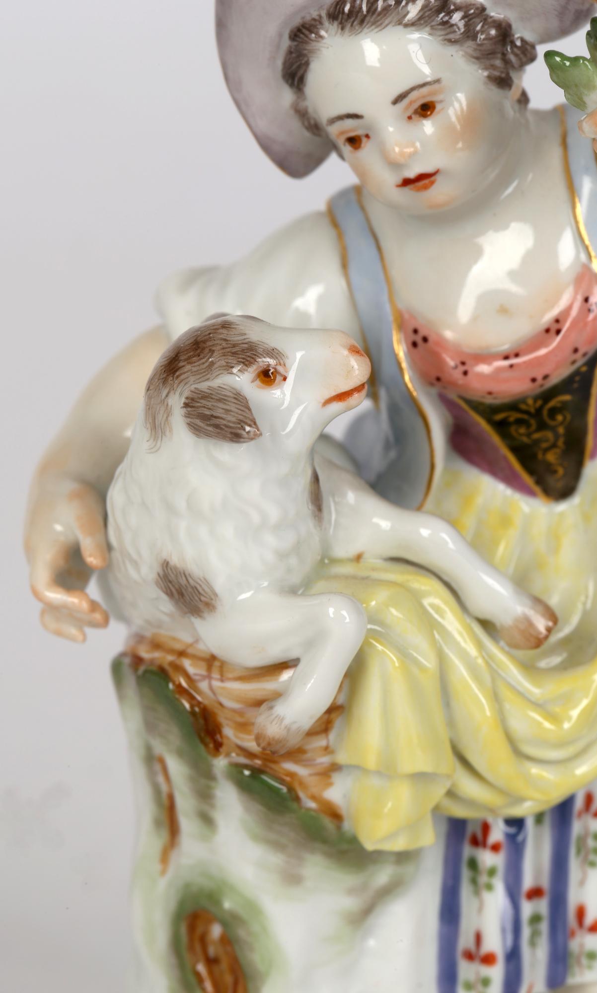 A fine and delightful German porcelain figurine of a girl feeding a sheep dating from the 19th or early 20th century. The figure stands on a scroll work rounded base decorated with relief molded gilded scrollwork. The girl is dressed in traditional
