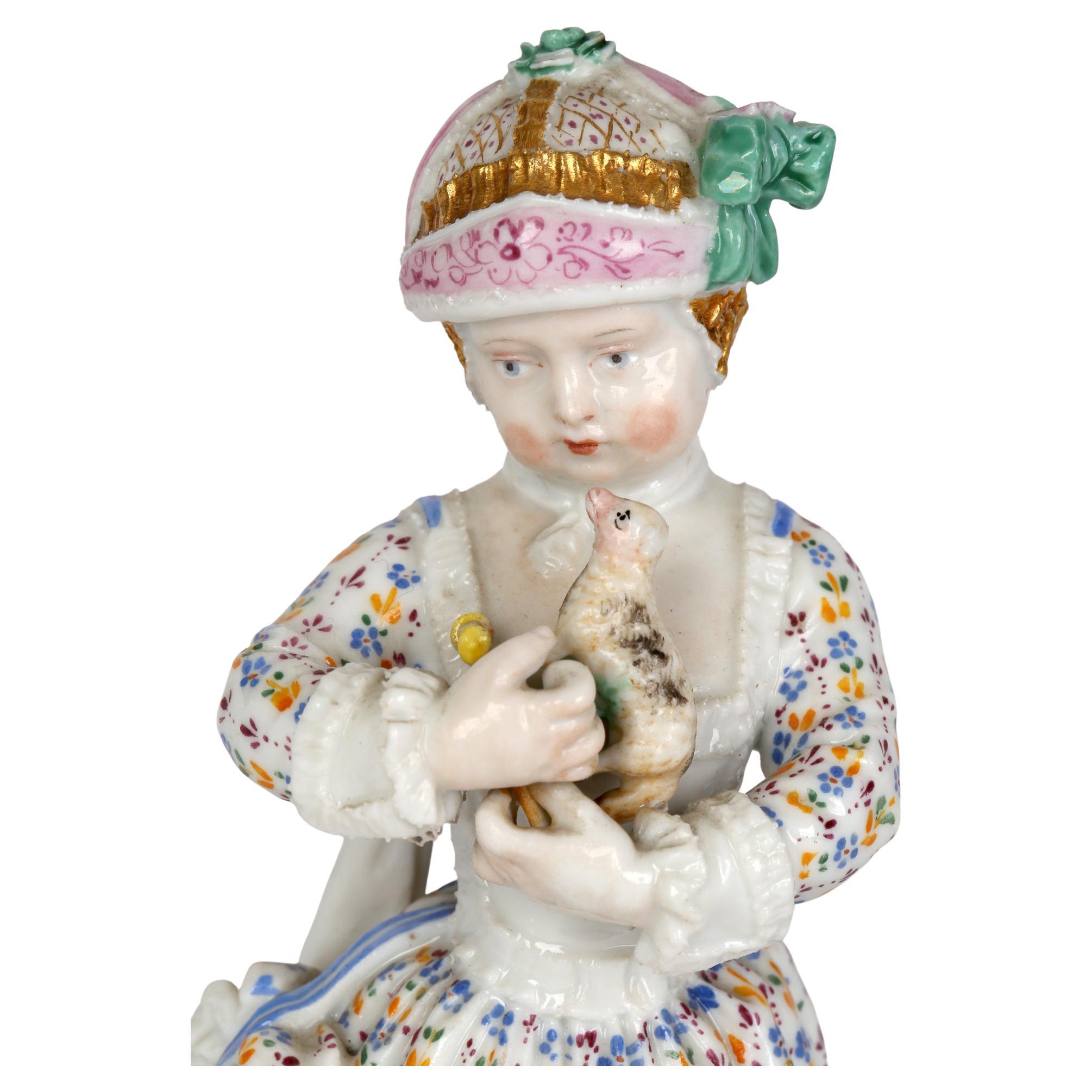A fine and charming German porcelain figurine of a young girl holding a pull along animal toy dating from the mid 19th century. This delightful figurine is beautifully detailed standing a rounded base molded in relief with scroll designs highlighted