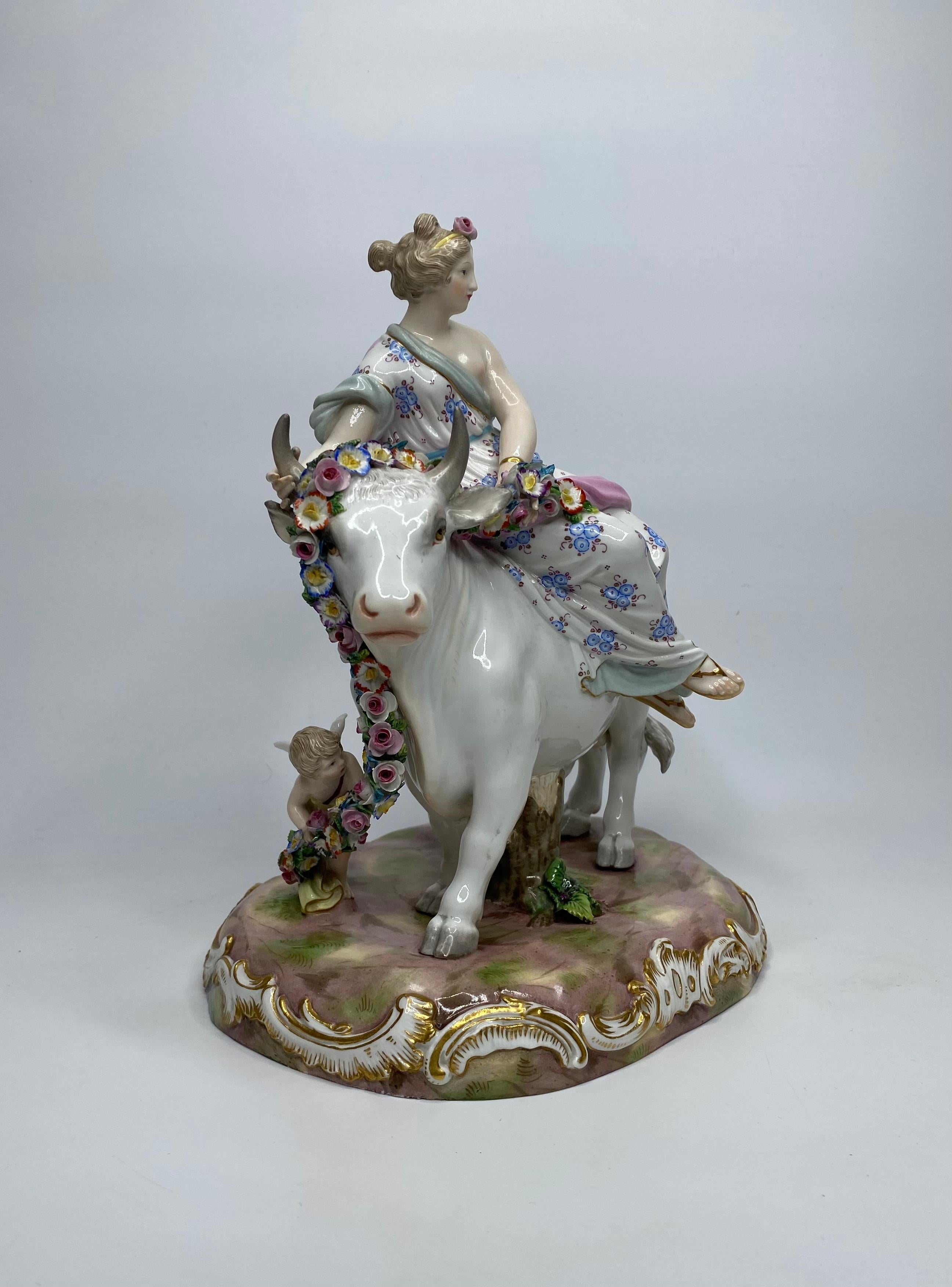Meissen porcelain figure group, Europa and the Bull, c. 1870. Finely modelled with Europa wearing flowing robes, seated upon a large bull. She holds a garland of flowers, and is attended by a Cupid. Her dress painted with groups of flowers.
Set upon