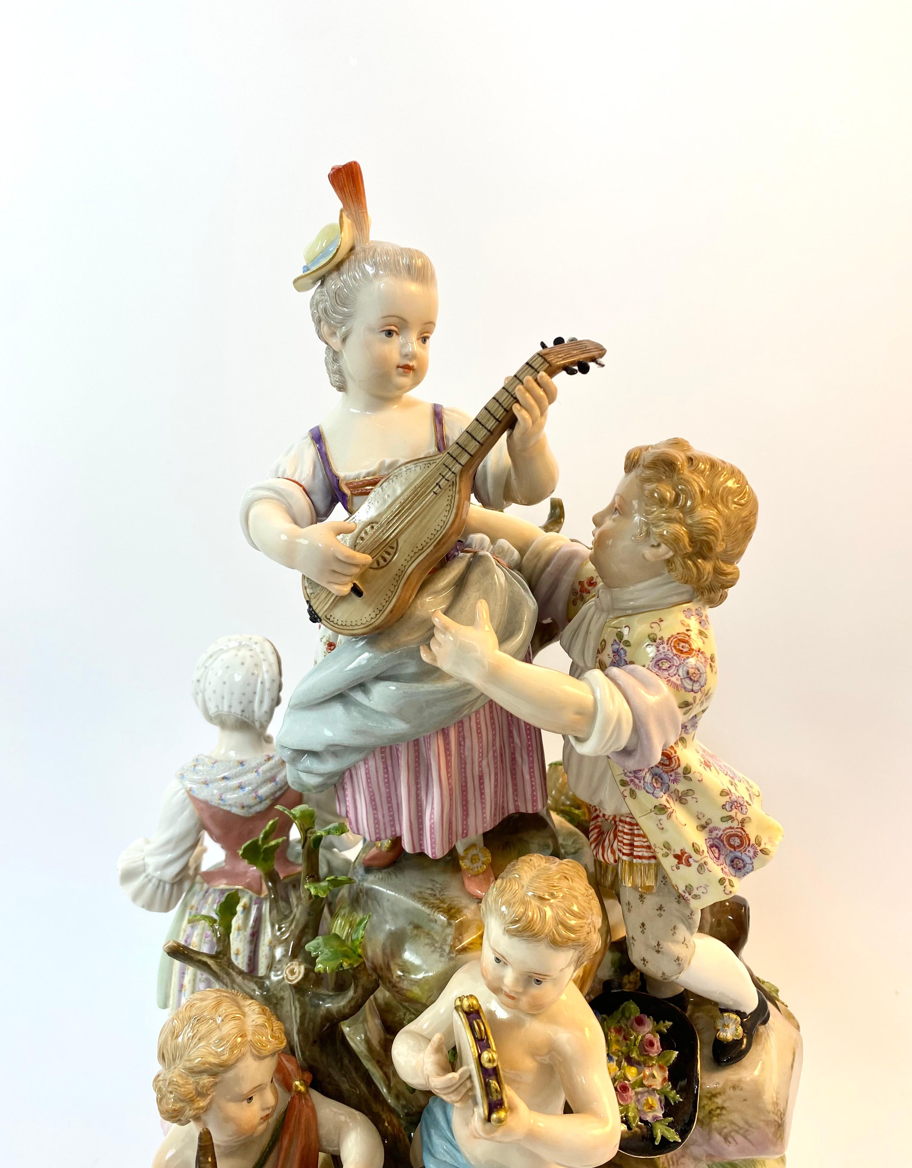 A fine and large Meissen porcelain group, c. 1870. The group modelled as figures in 18th Century costume, comprising a young man pours a glass of wine for a girl, whilst he holds a violin and bow, whilst she carries a scroll of music. Behind them, a
