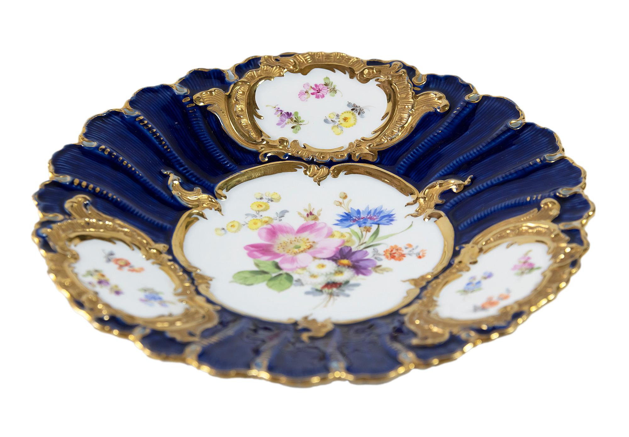 Meissen Porcelain plate with hand painted floral motives and cobalt blue color with rich gold decor.
  