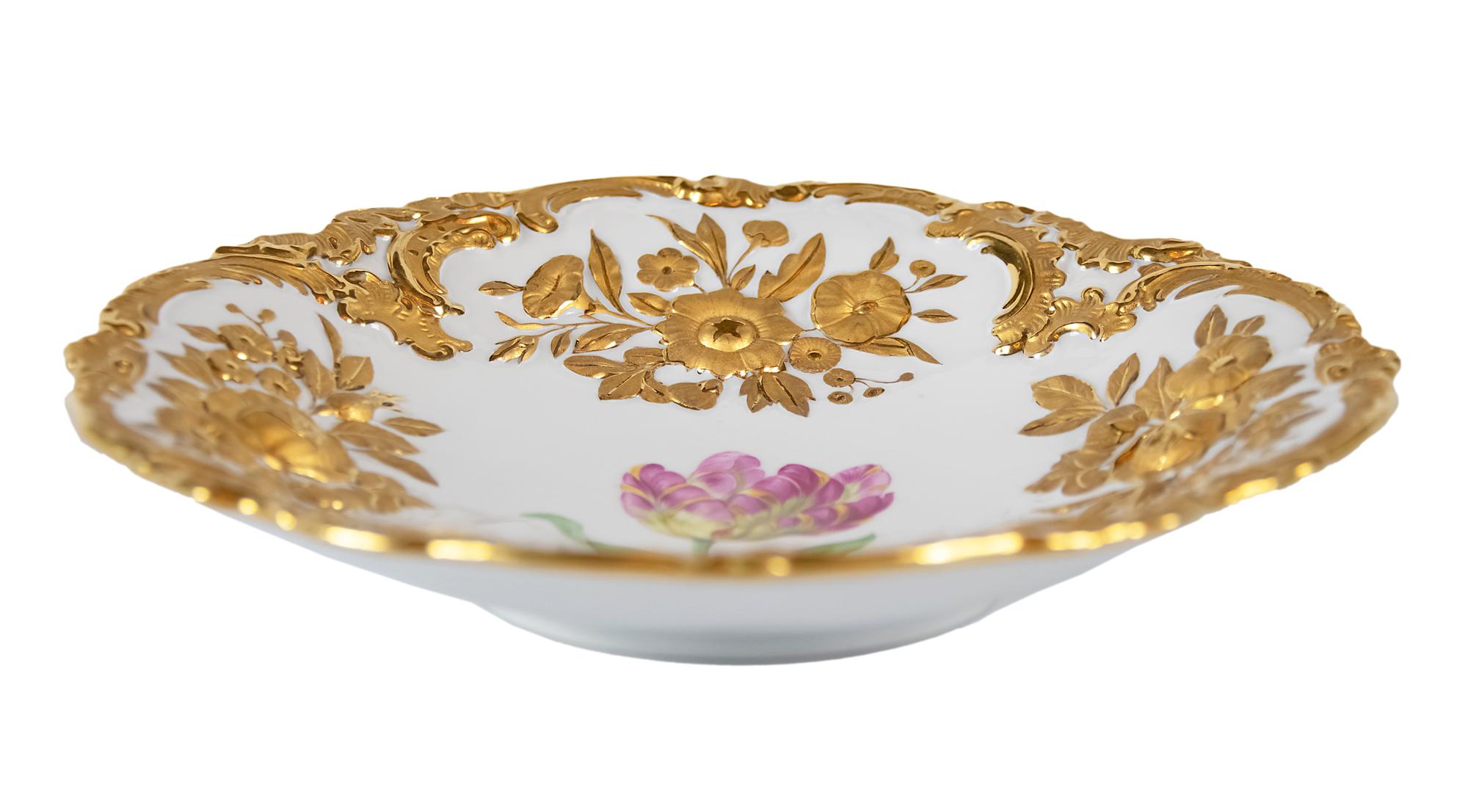 Meissen porcelain deep plate with hand painted relief floral motives and rich gold decor.
 
