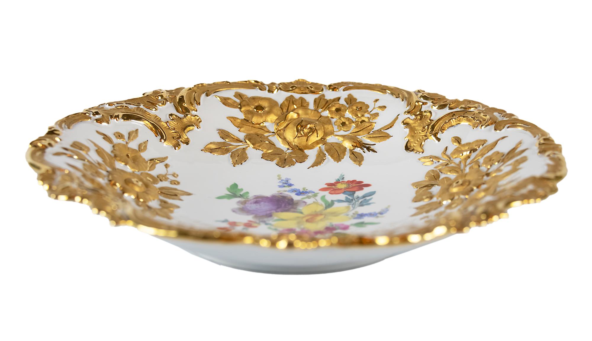 Meissen porcelain deep plate with hand painted relief floral motives and rich gold decor.
 