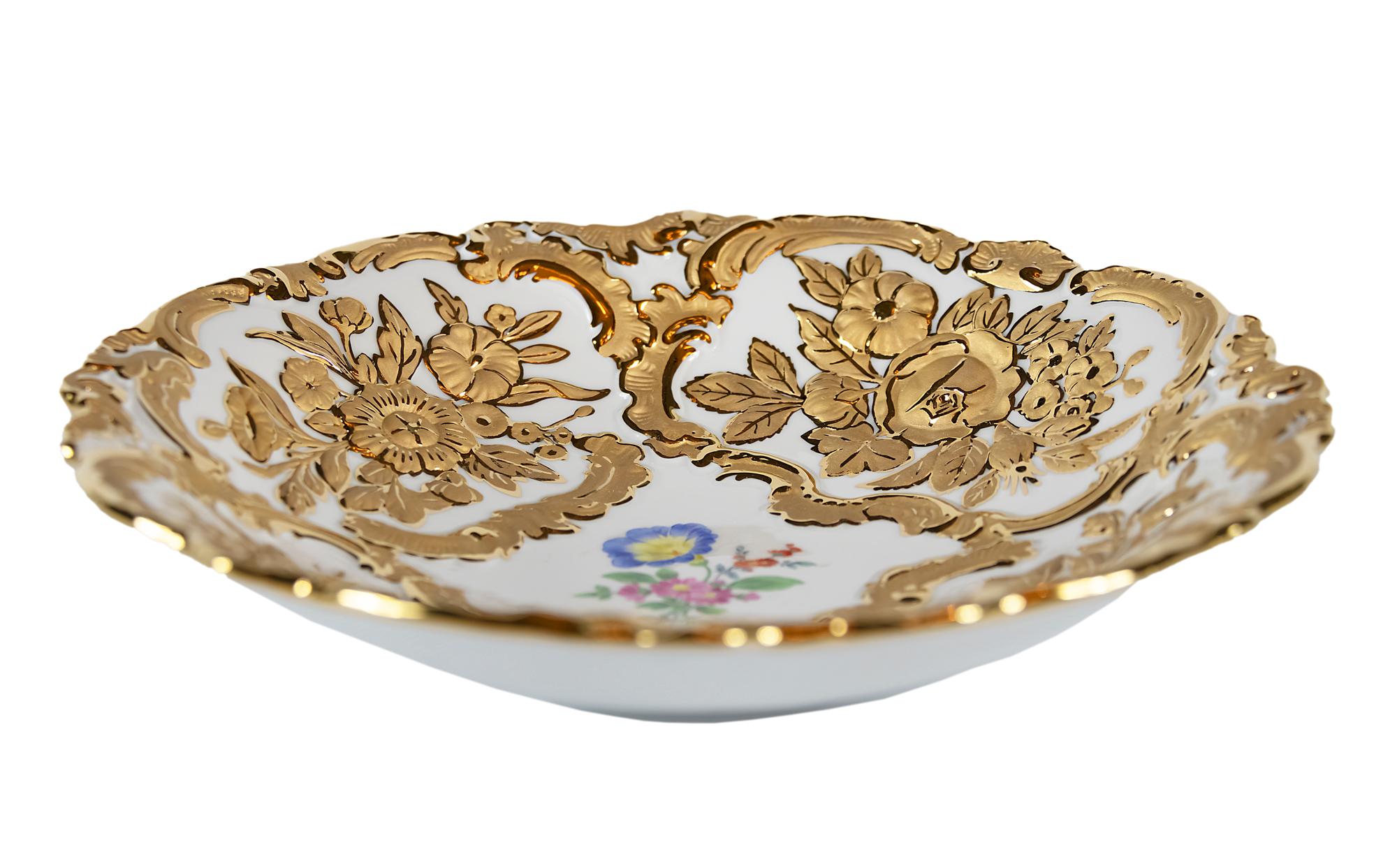 Meissen porcelain deep plate with hand painted relief floral motives and rich gold decor.
 