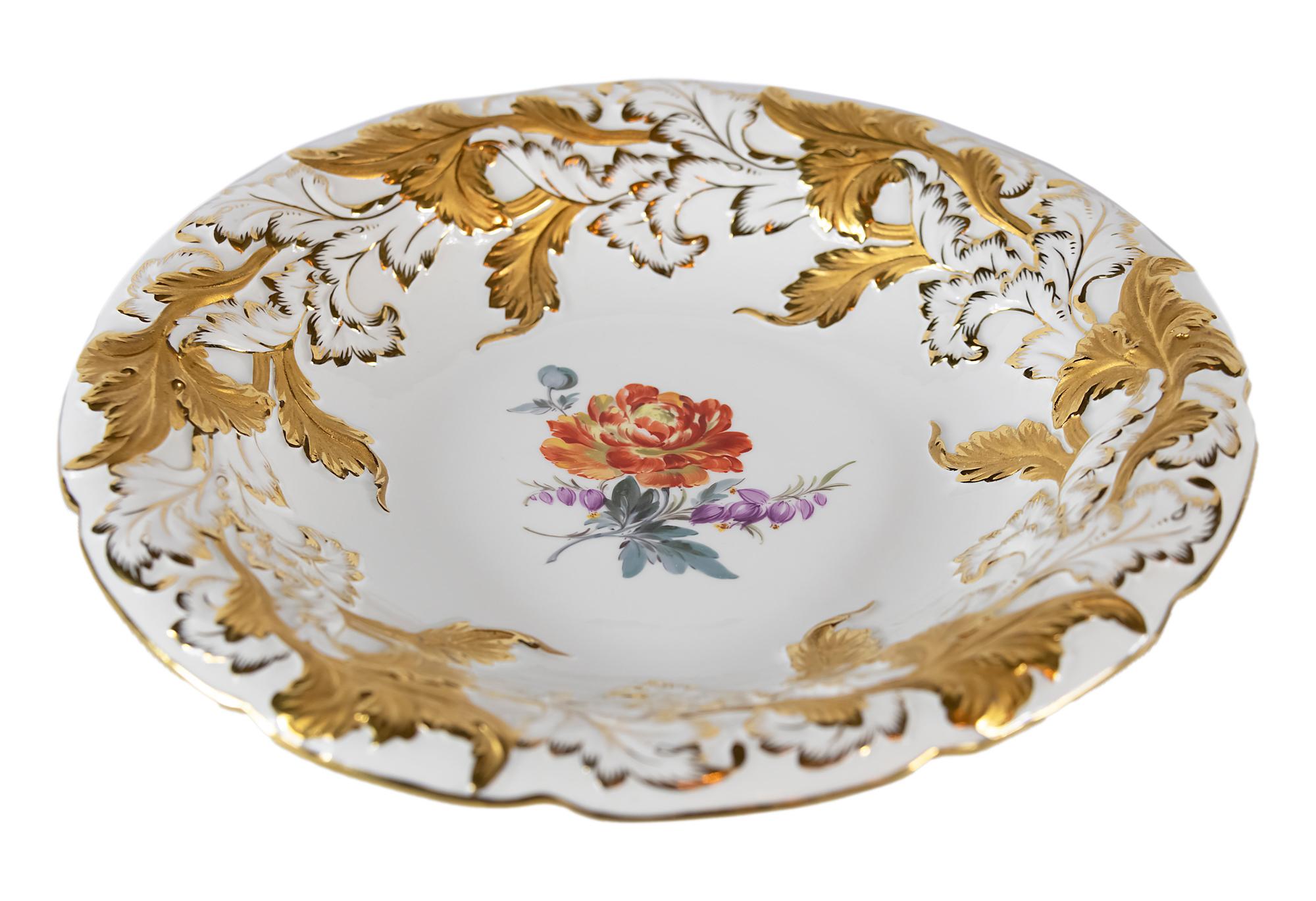 Meissen Porcelain deep plate with hand painted relief floral motives and gold decor.
  