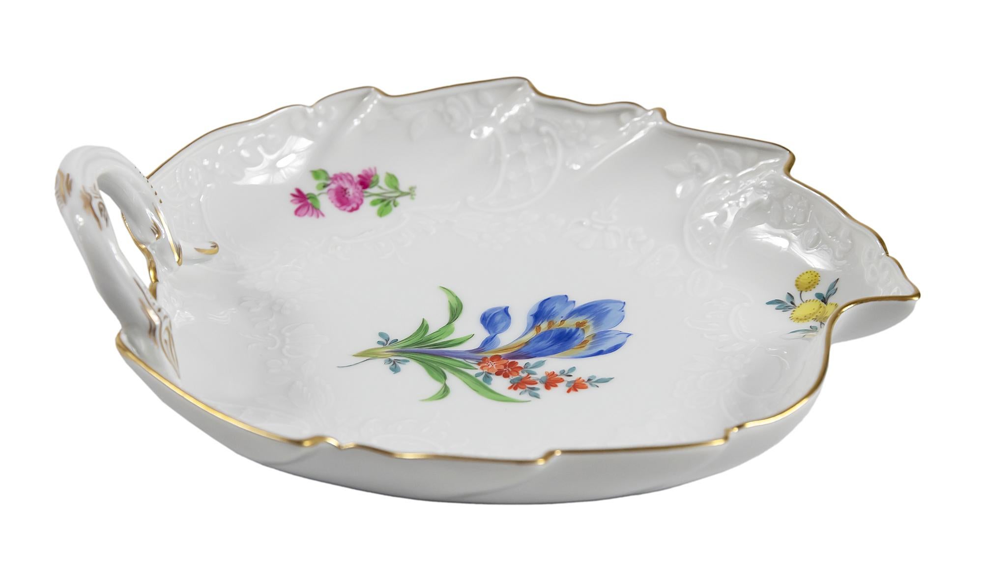 Meissen Porcelain leaf form plate with handle.
This piece is hand painted with floral motives and decorated with gold on edge and handle.
Signed on the bottom.