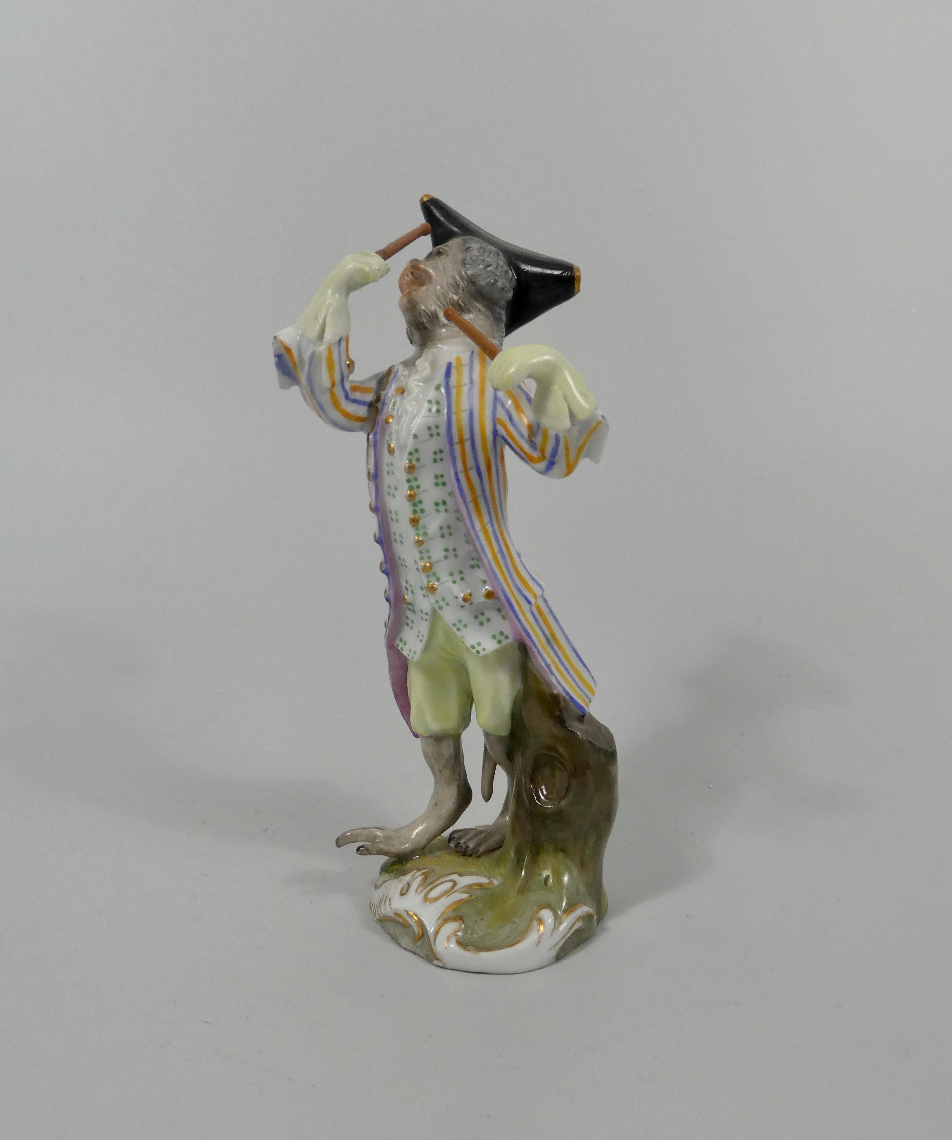A fine Meissen porcelain figure, circa 1870. Beautifully modelled as a standing monkey wearing 18th century costume, and wielding drum sticks. Set upon a grassy mound base, edged and gilded in moulded rococo scroll,
Blue crossed swords mark to the