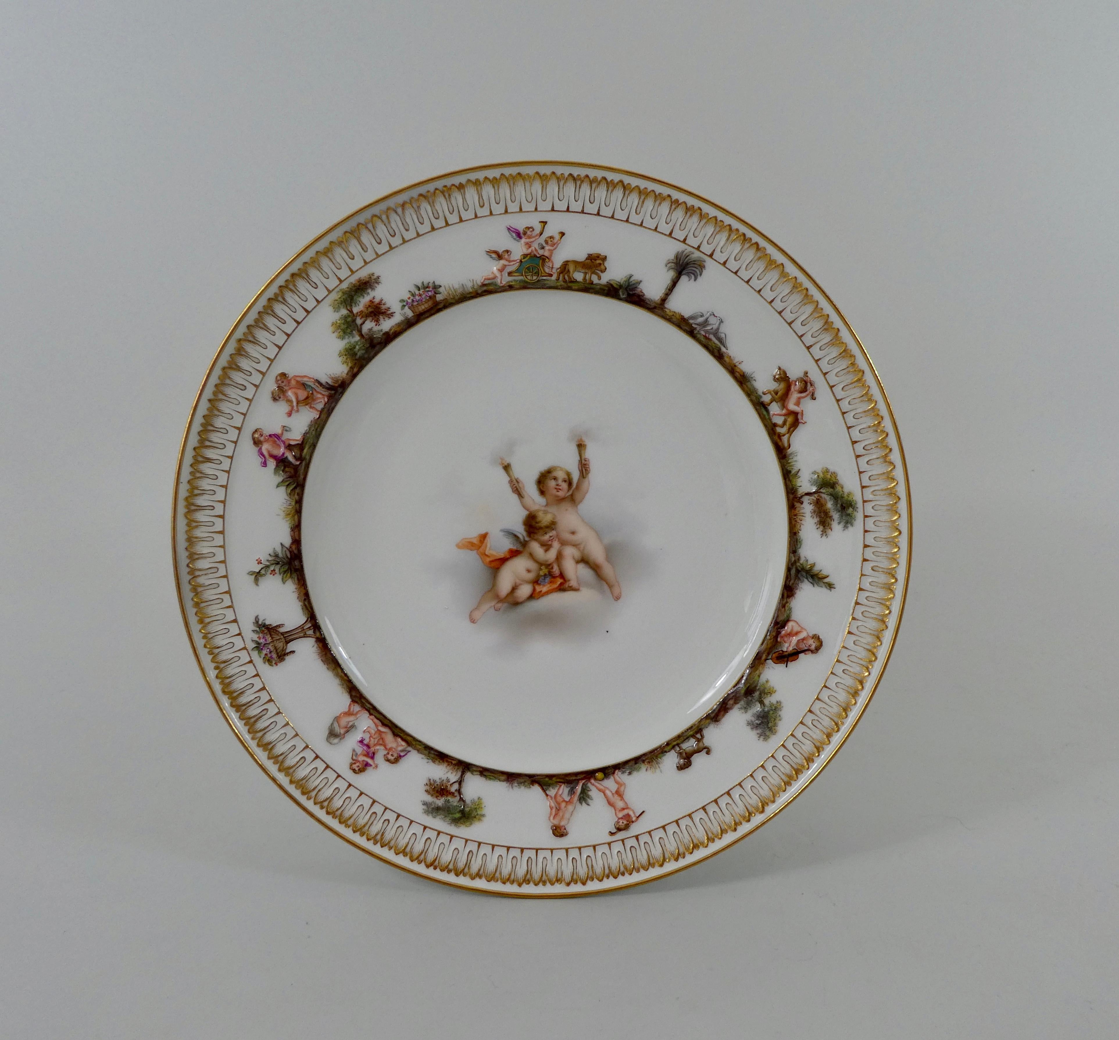 A fine Meissen porcelain plate, circa 1870. Beautifully hand painted to the centre, with a scene of two Putti, amongst clouds. One Putti carrying flaming torches, the second holding a bunch of grapes. The border moulded and painted in Capo di Monte
