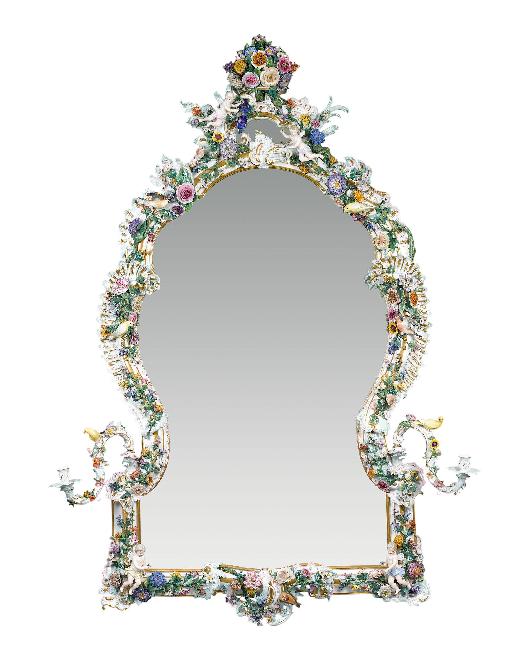 This sumptuous Meissen porcelain mirror is a work of astounding artistry and rarity that would only have been created for the most affluent clients. Exquisitely hand-painted in polychrome with gilt accents, the bountiful frame is adorned with all