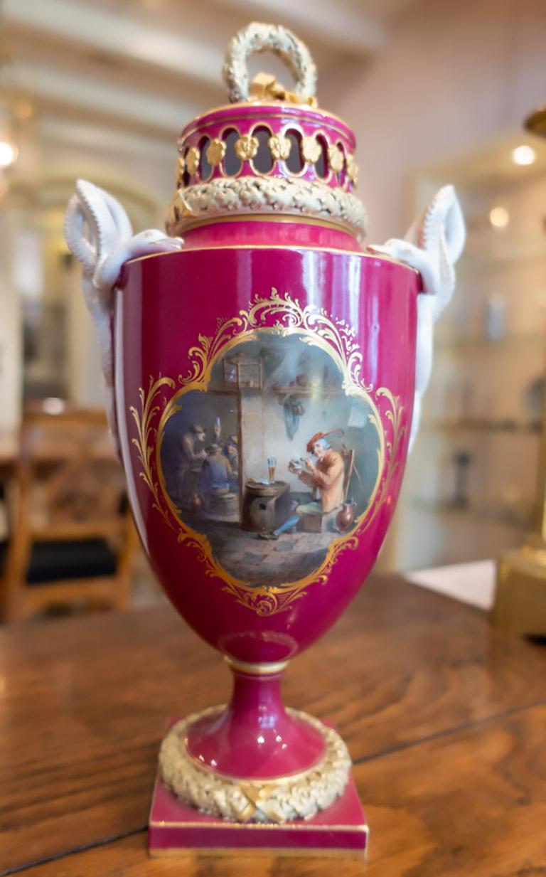 Spectacular Meissen Porcelain Snake Handle Vase with Cover.
Small dimensions = rarer than large vases. 
Serpentine handles, lids richly decorated, on the wall double-sided painting.
Front motive: Dutch pub scene.
Backside motive: bouquet of flowers.