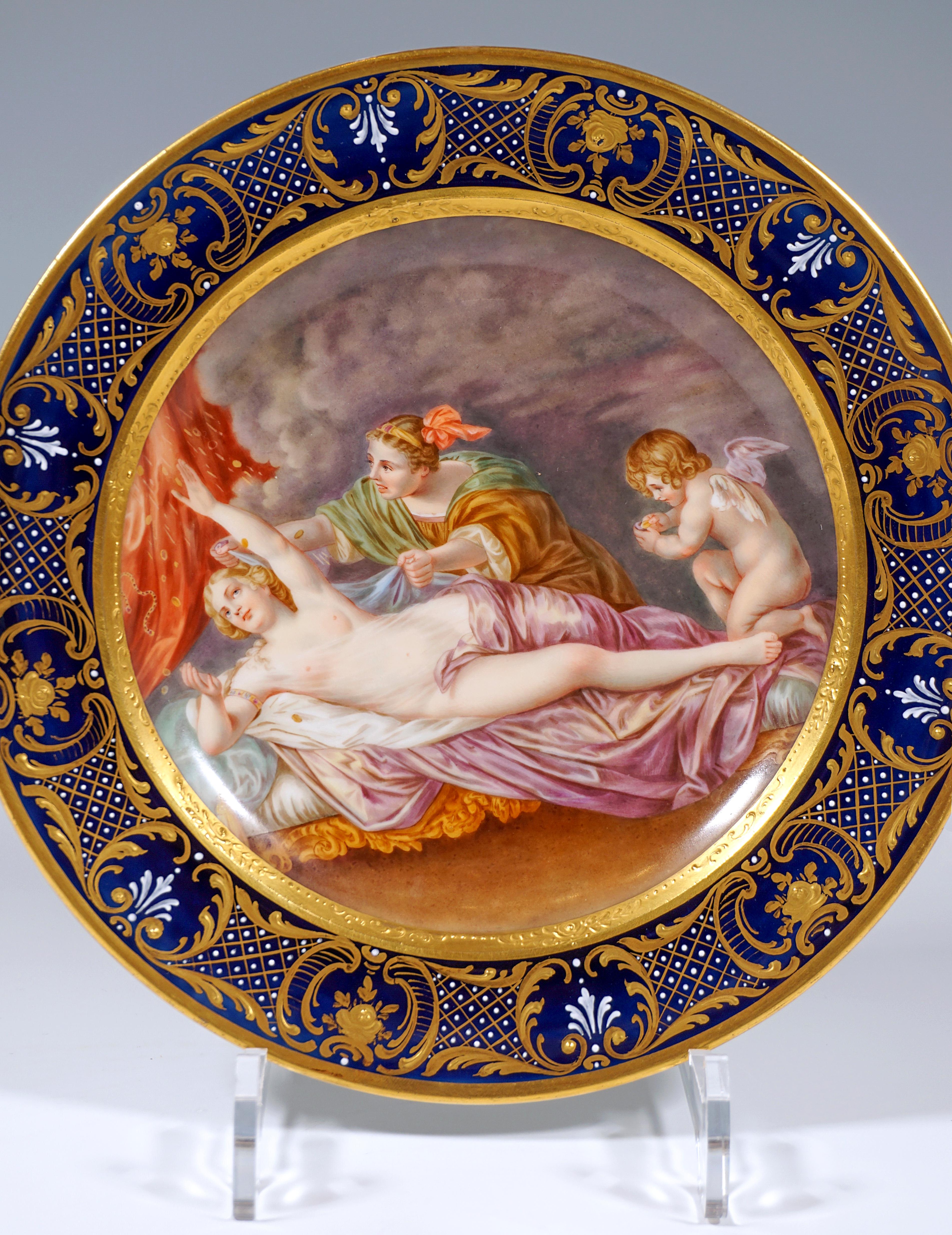 Exceptionally decorated porcelain plate:
Center of the porcelain plate fully decorated with the delicately painted image of Danae after a painting by Anthonis van Dyck in the finest polychrome painting, framed by a matte gold-pastos painted band